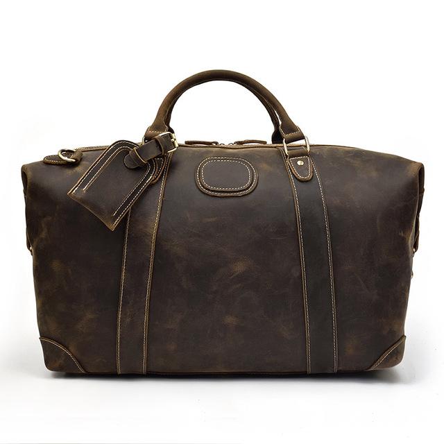 The Eira Duffle Bag made of premium crazy horse leather in two shades of brown, showcasing its spacious design and comfortable leather handles.