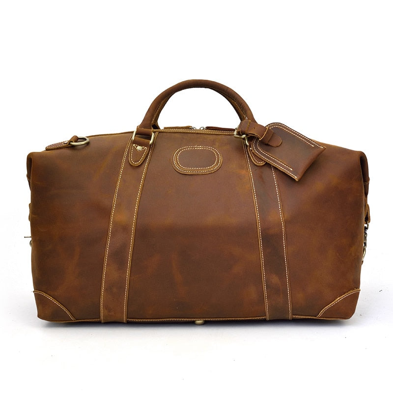 The Eira Duffle Bag made of premium crazy horse leather in two shades of brown, showcasing its spacious design and comfortable leather handles.