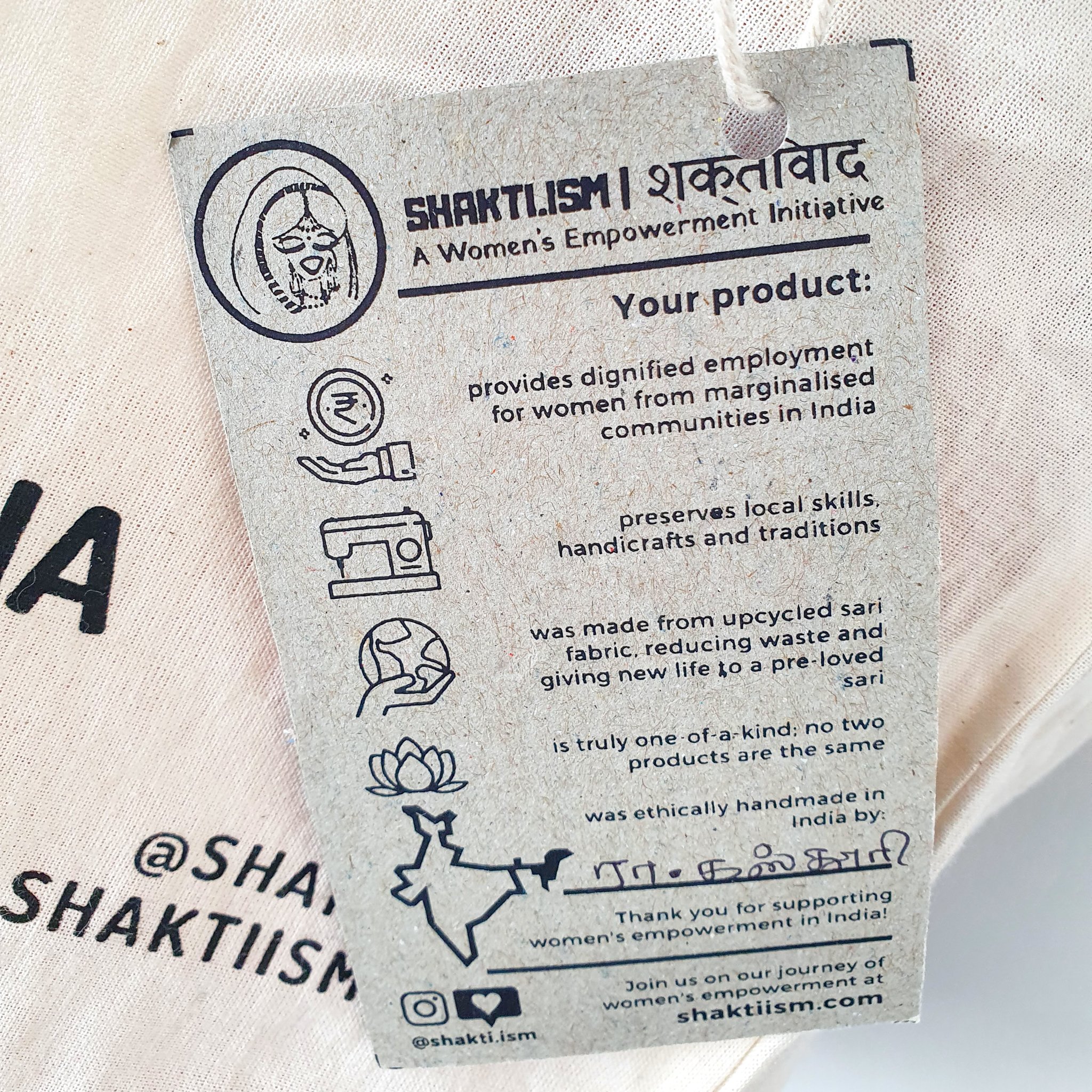 A vibrant Independence sari tote bag handcrafted from repurposed sari fabric, showcasing unique patterns and colors, with a message promoting women's economic independence.