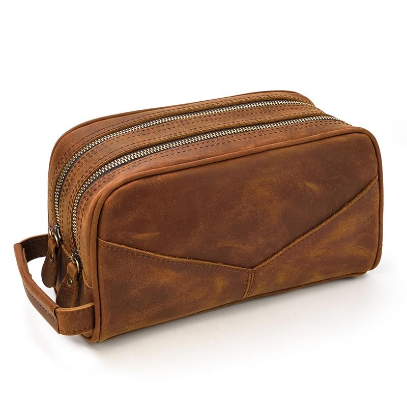 The Nomad Toiletry Bag made of genuine crazy horse leather, featuring two large pockets and a front pocket for phone storage, ideal for travel.