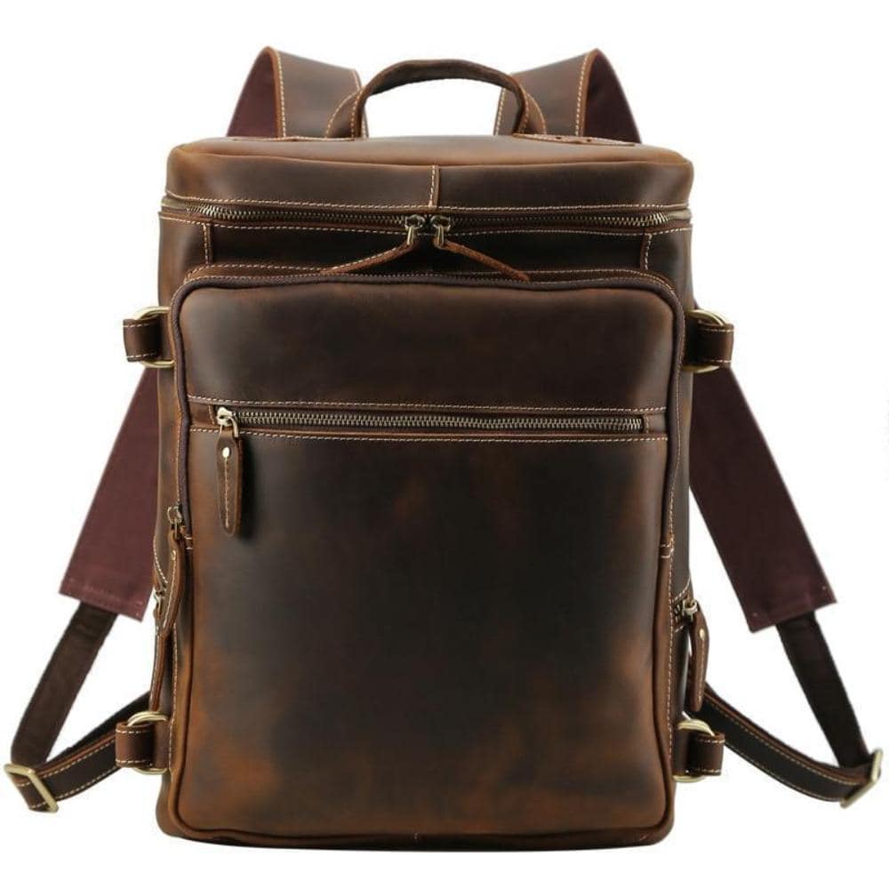 The Raoul Backpack, a handmade vintage leather backpack featuring multiple pockets and adjustable straps, showcasing its rustic charm and durability.