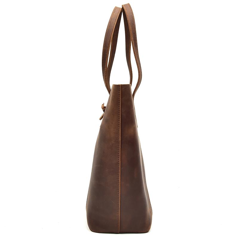 The Taavi Tote, a handcrafted leather tote bag, showcasing its unique crazy horse leather texture and spacious design.