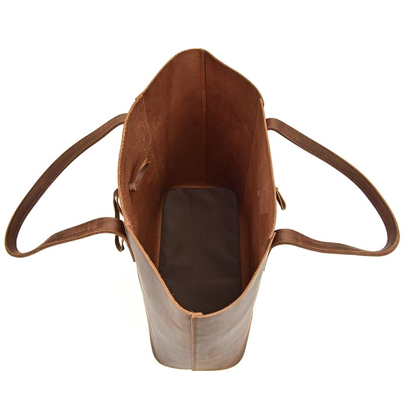 The Taavi Tote, a handcrafted leather tote bag, showcasing its unique crazy horse leather texture and spacious design.