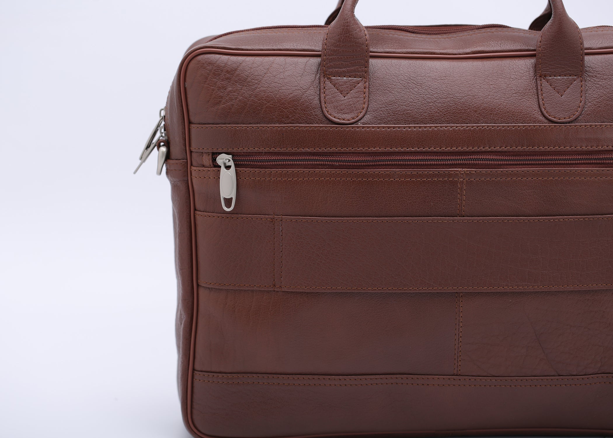 Tan leather briefcase bag with multiple compartments and adjustable shoulder strap, designed for professionals.