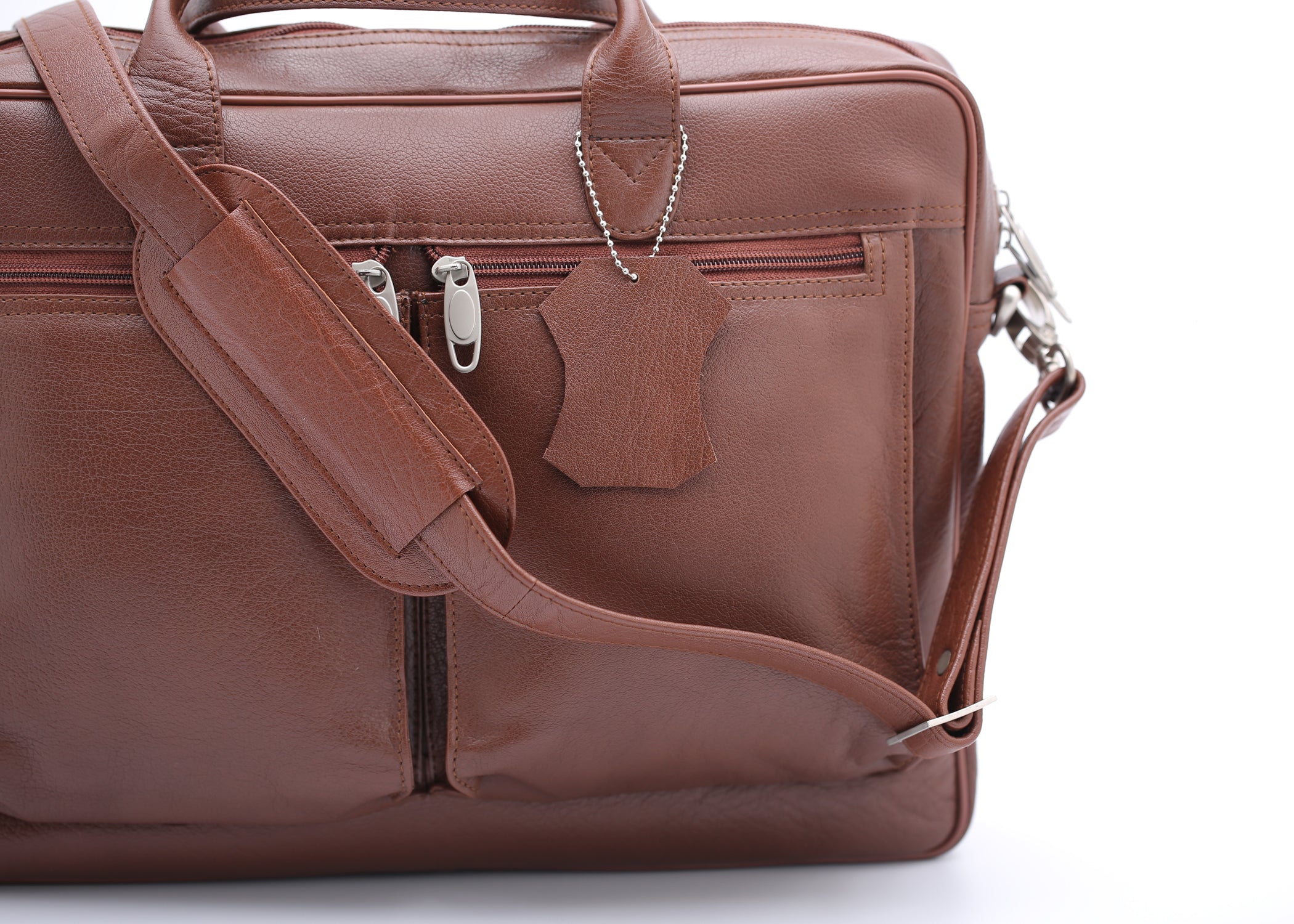 Tan leather briefcase bag with multiple compartments and adjustable shoulder strap, designed for professionals.