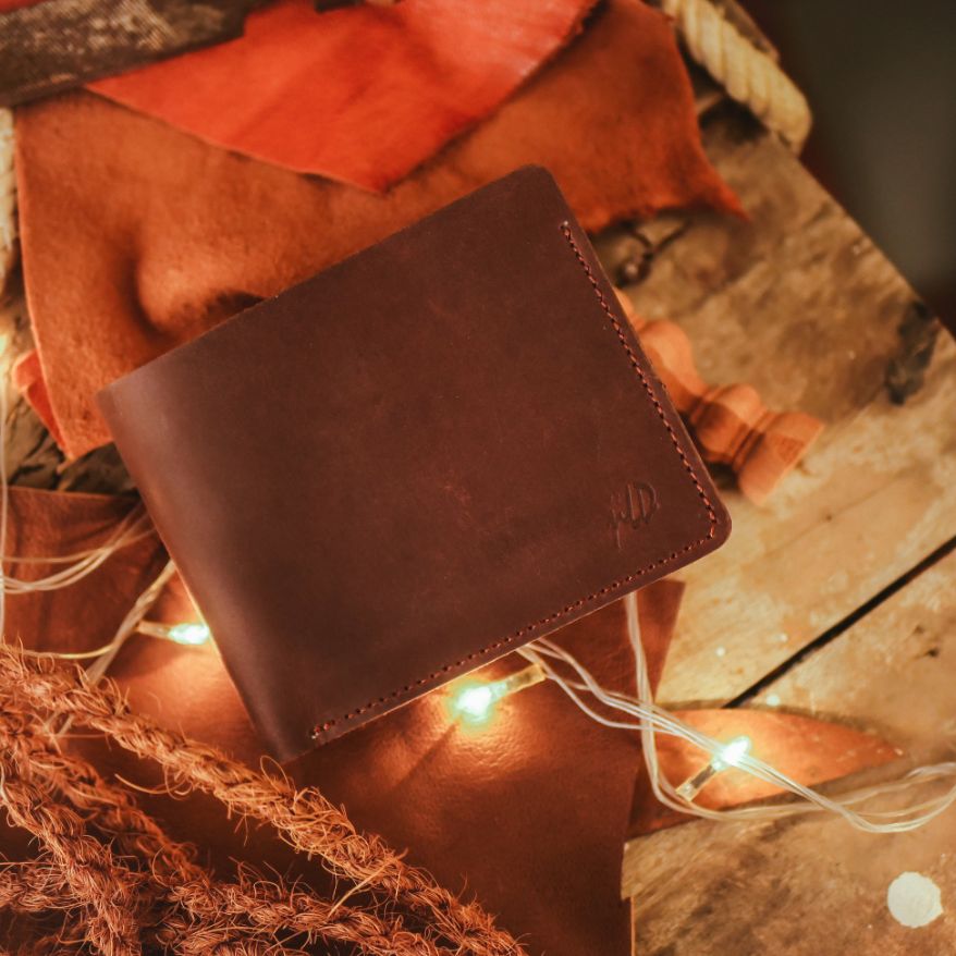 The Vault Vintage Leather Wallet in Dark Brown, showcasing its unique vintage wash and hand-pressed aged edges.