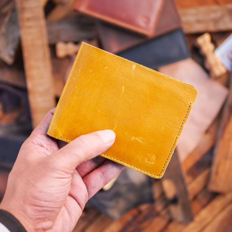 The Vault Vintage Leather Wallet in Arch-Wood Brown, showcasing its unique vintage wash and hand-pressed edges.