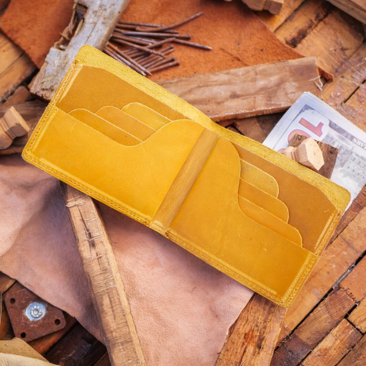 The Vault Vintage Leather Wallet in Arch-Wood Brown, showcasing its unique vintage wash and hand-pressed edges.