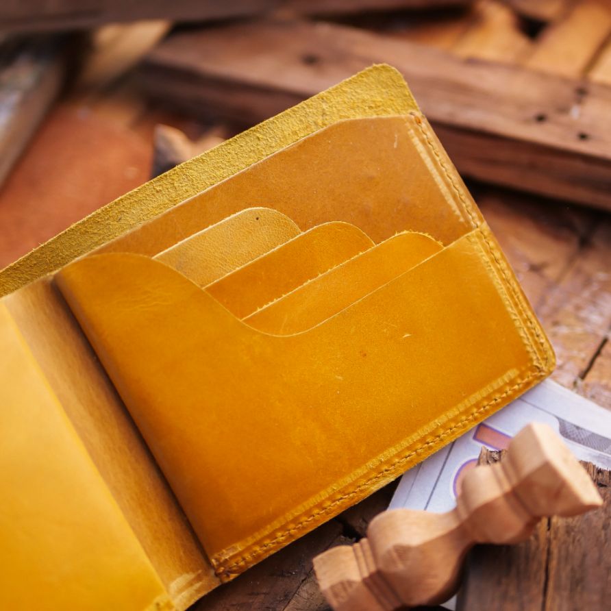 The Vault Vintage Leather Wallet in Arch-Wood Brown, showcasing its unique vintage wash and hand-pressed edges.