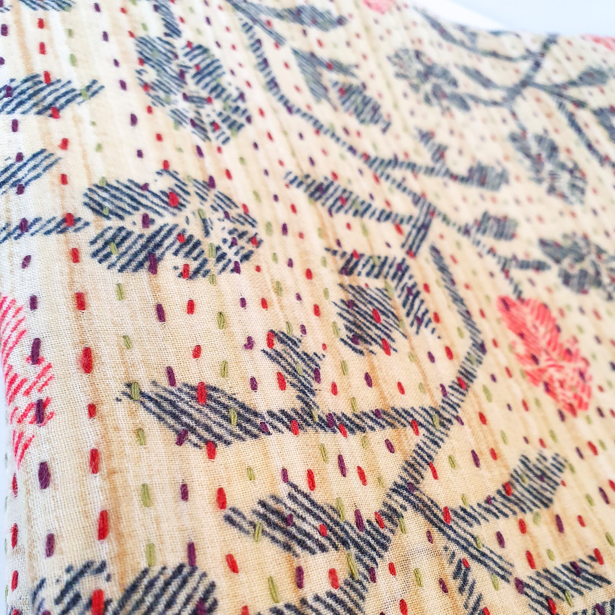 Upcycled sari clutch featuring vibrant colors and intricate kantha stitch embroidery, perfect for carrying essentials.