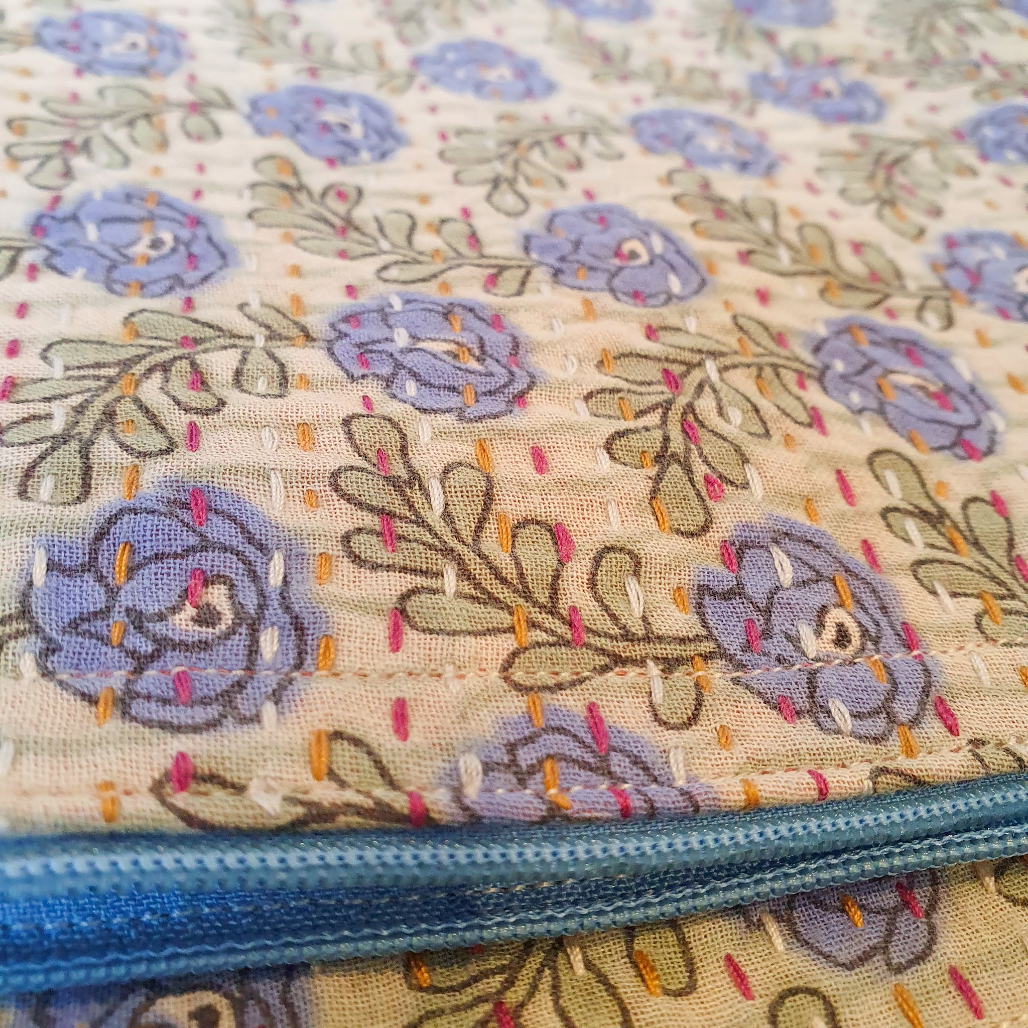 Upcycled sari clutch featuring vibrant colors and intricate kantha stitch embroidery, perfect for carrying essentials.