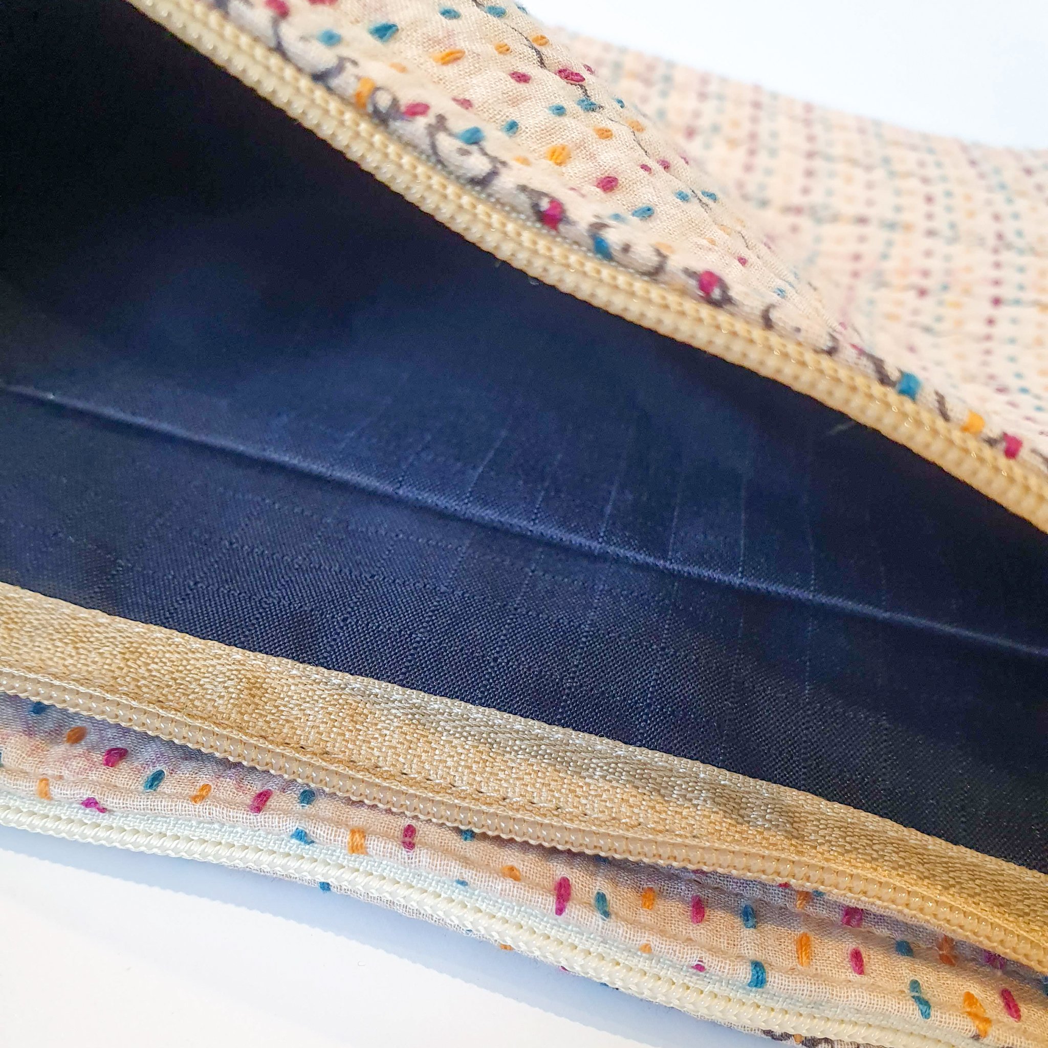 Upcycled sari clutch featuring vibrant colors and intricate kantha stitch embroidery, perfect for carrying essentials.