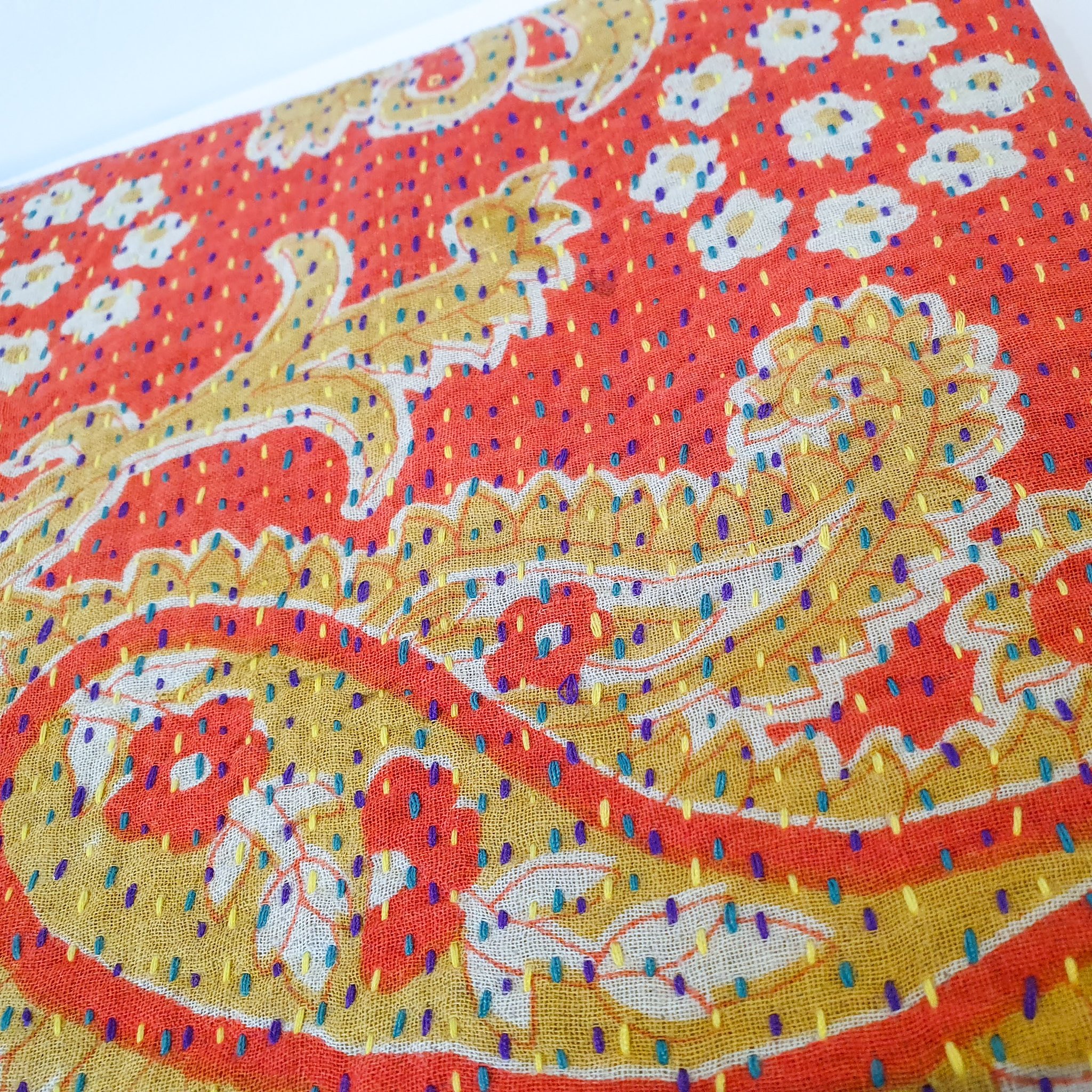 Upcycled sari clutch featuring vibrant colors and intricate kantha stitch embroidery, perfect for carrying essentials.