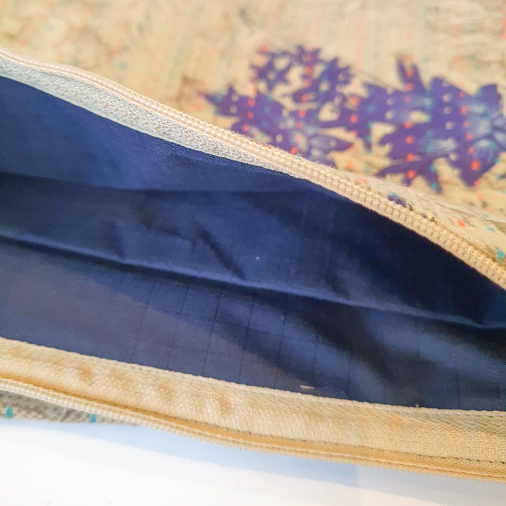 Upcycled sari clutch featuring vibrant colors and intricate kantha stitch embroidery, perfect for carrying essentials.