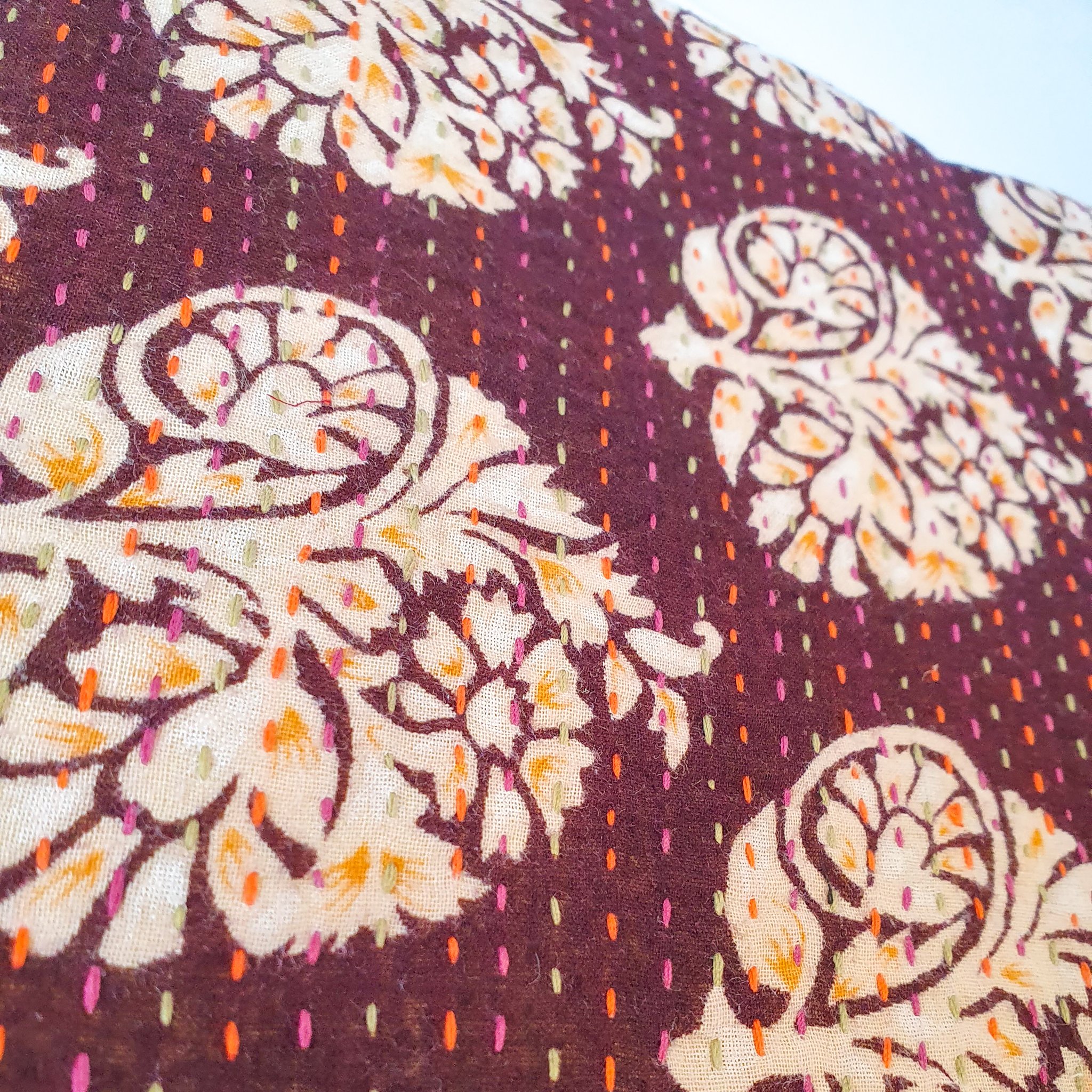 Upcycled sari clutch featuring vibrant colors and intricate kantha stitch embroidery, perfect for carrying essentials.