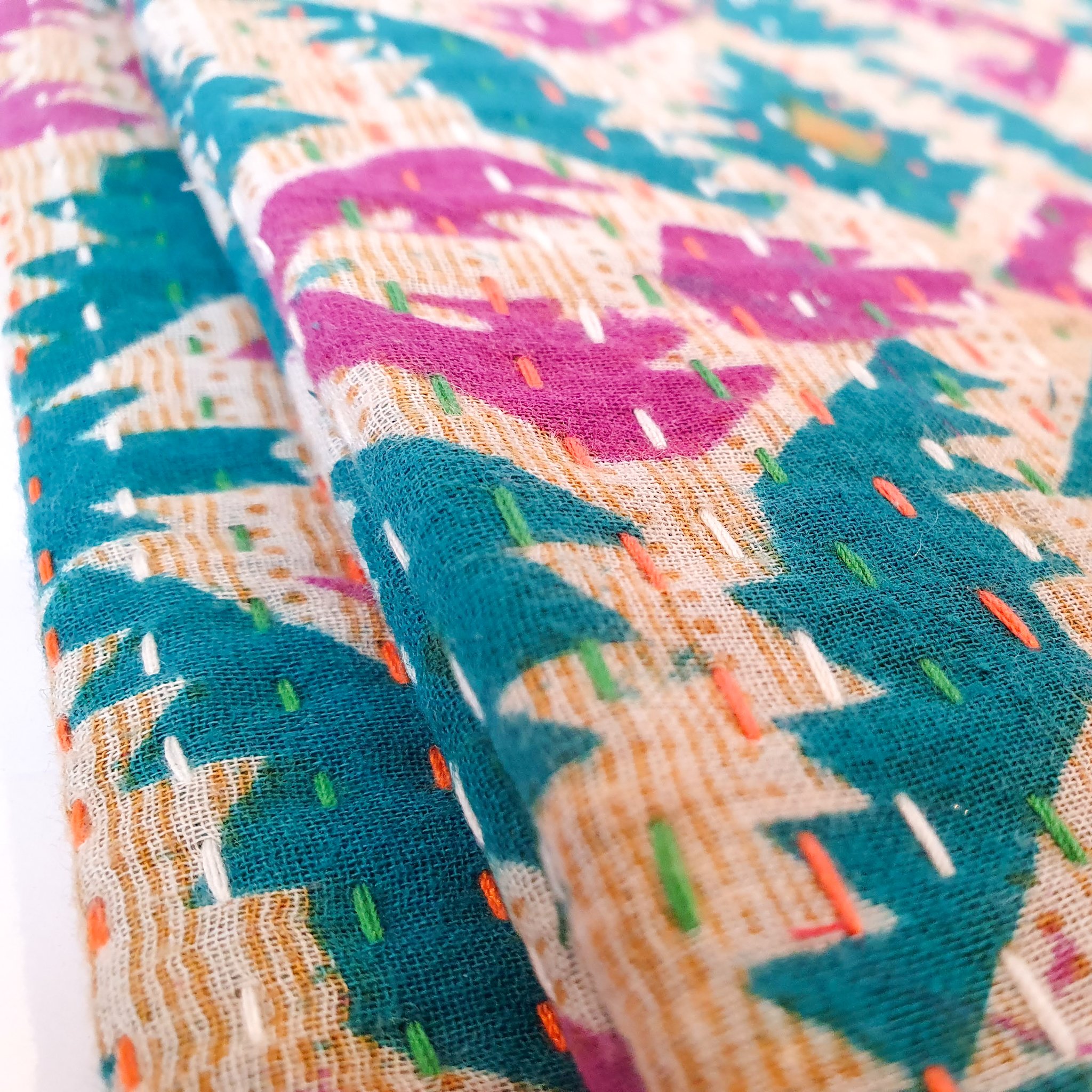 Upcycled sari clutch featuring vibrant colors and intricate kantha stitch embroidery, perfect for carrying essentials.