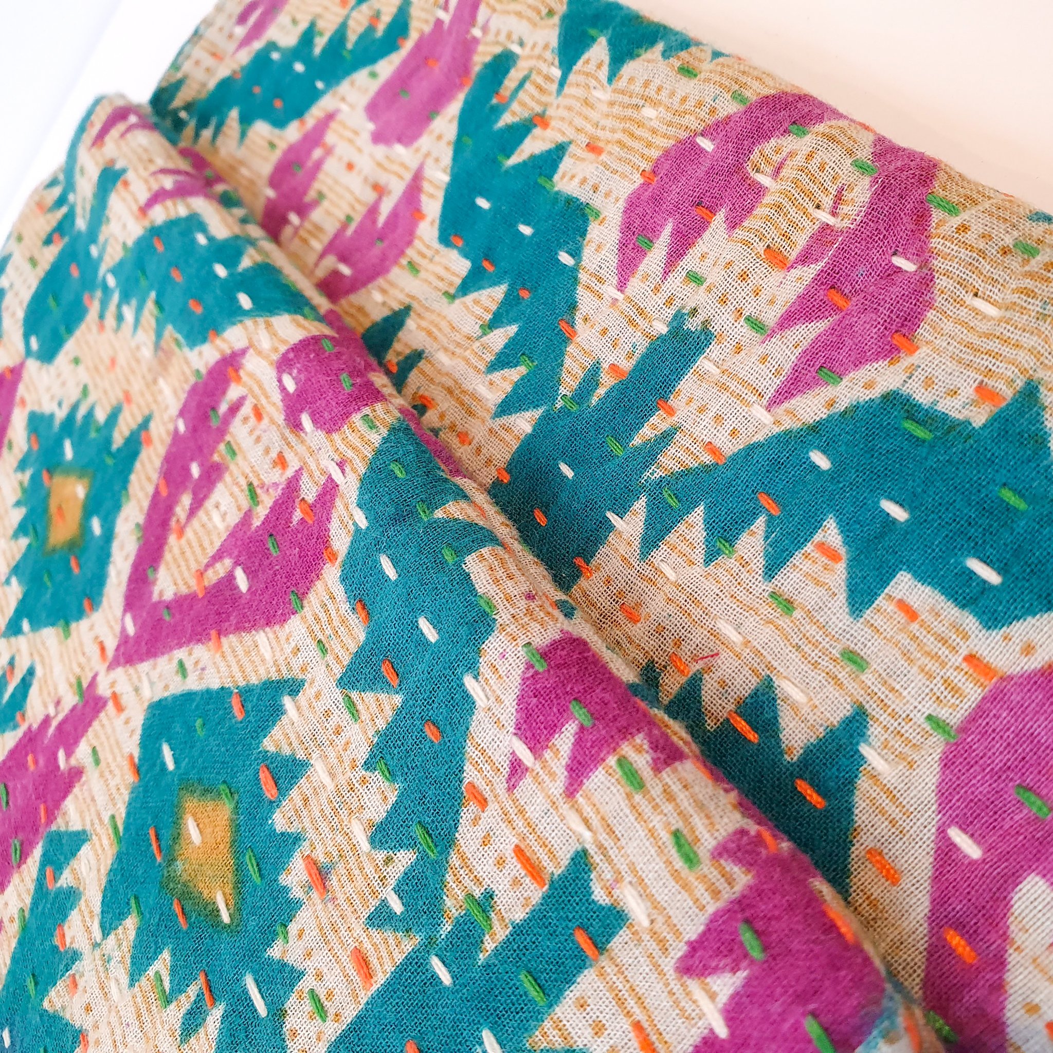 Upcycled sari clutch featuring vibrant colors and intricate kantha stitch embroidery, perfect for carrying essentials.