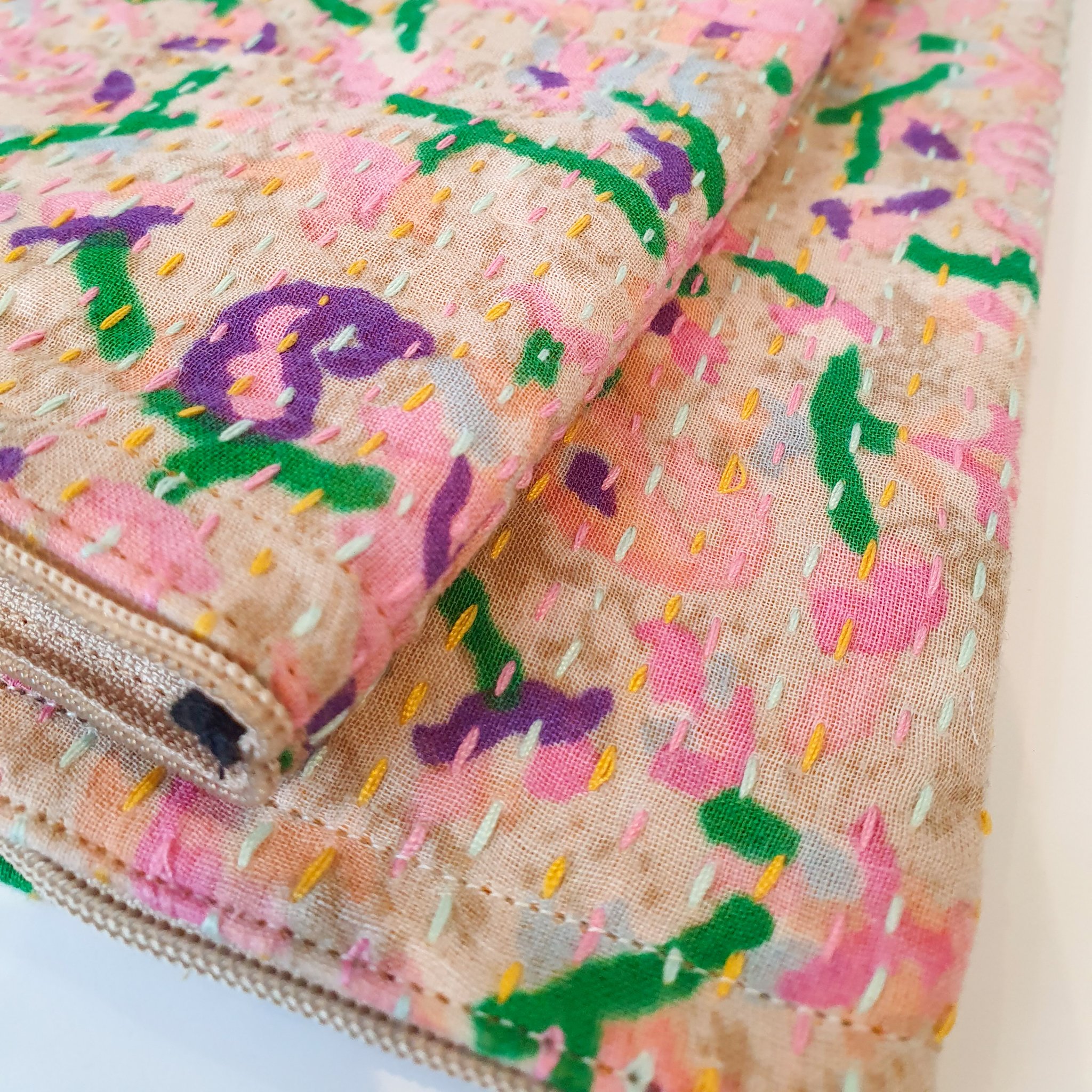 Upcycled sari clutch featuring vibrant colors and intricate kantha stitch embroidery, perfect for carrying essentials.