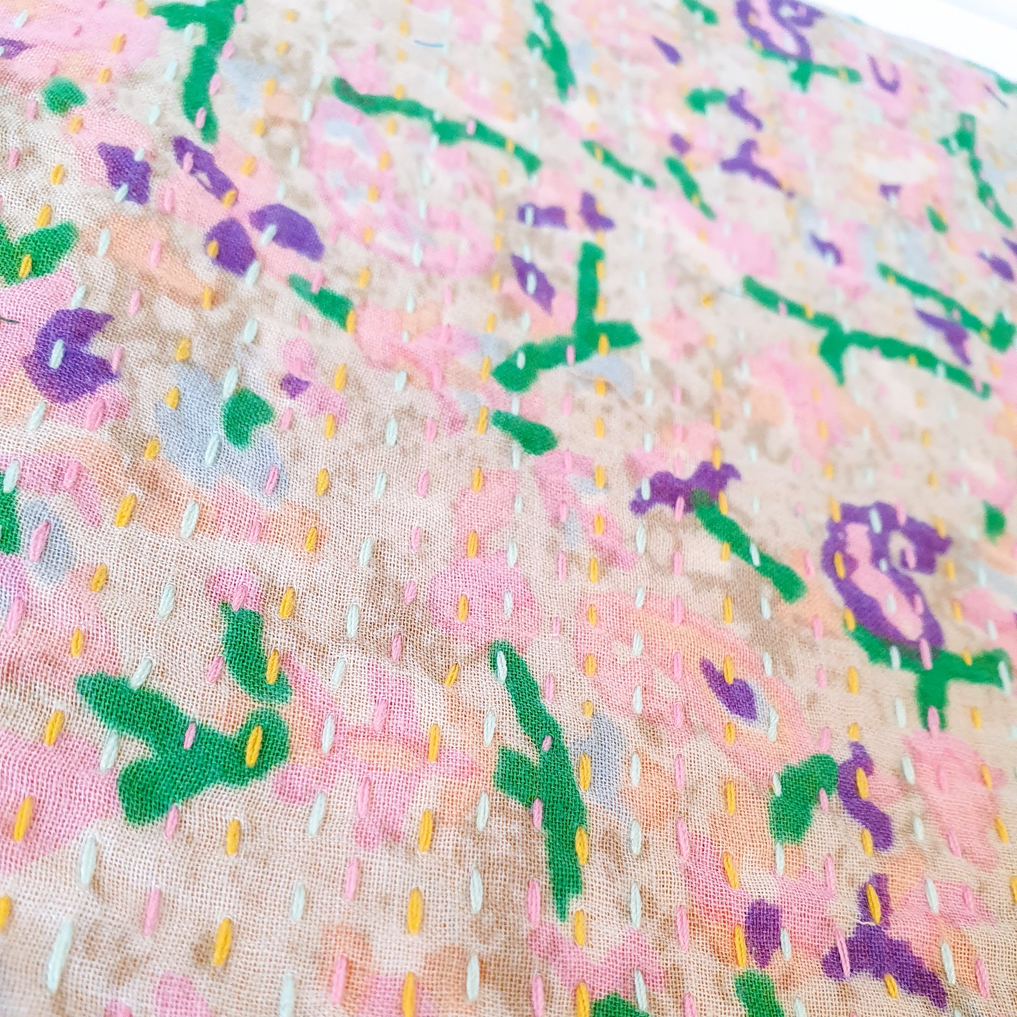 Upcycled sari clutch featuring vibrant colors and intricate kantha stitch embroidery, perfect for carrying essentials.