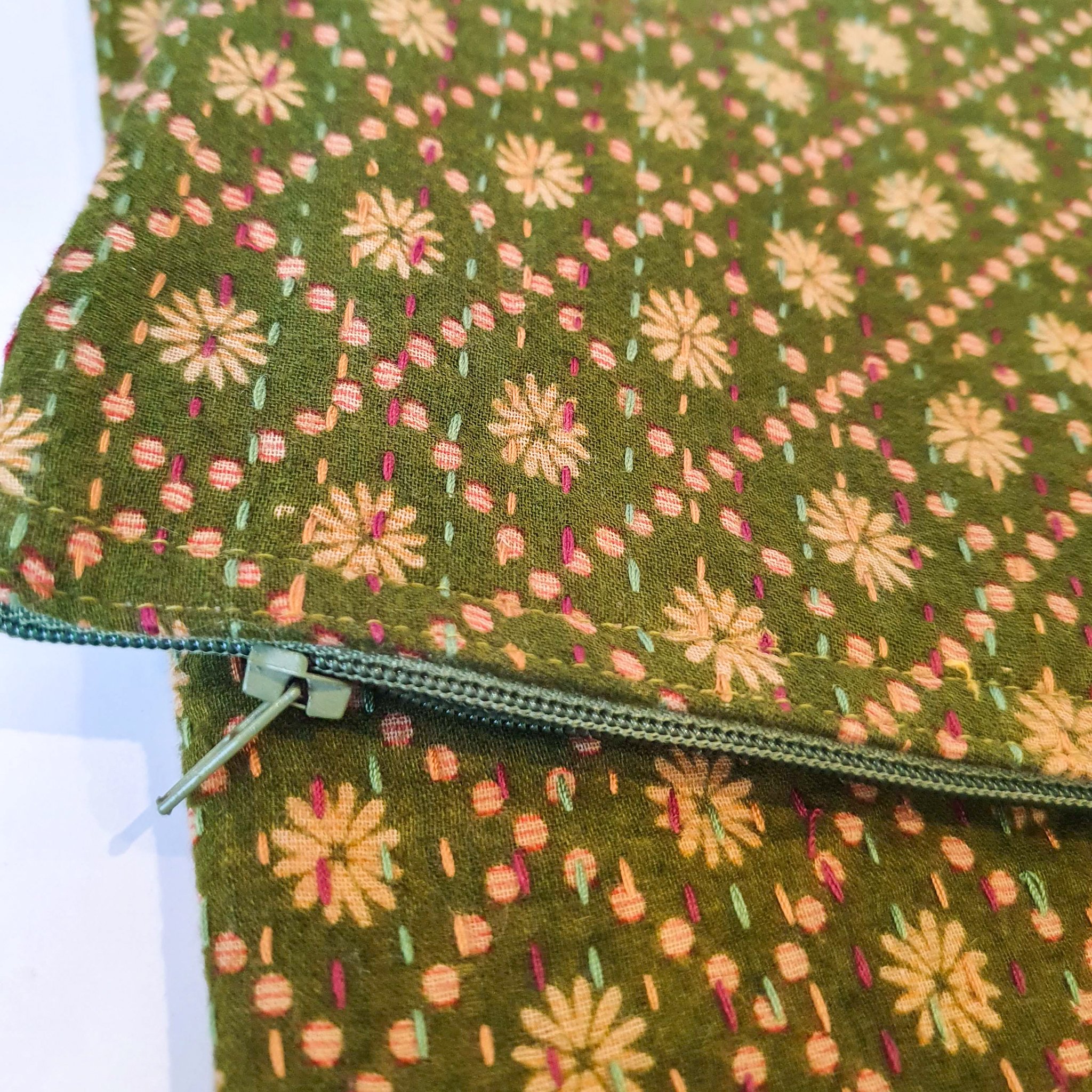 Upcycled sari clutch featuring vibrant colors and intricate kantha stitch embroidery, perfect for carrying essentials.