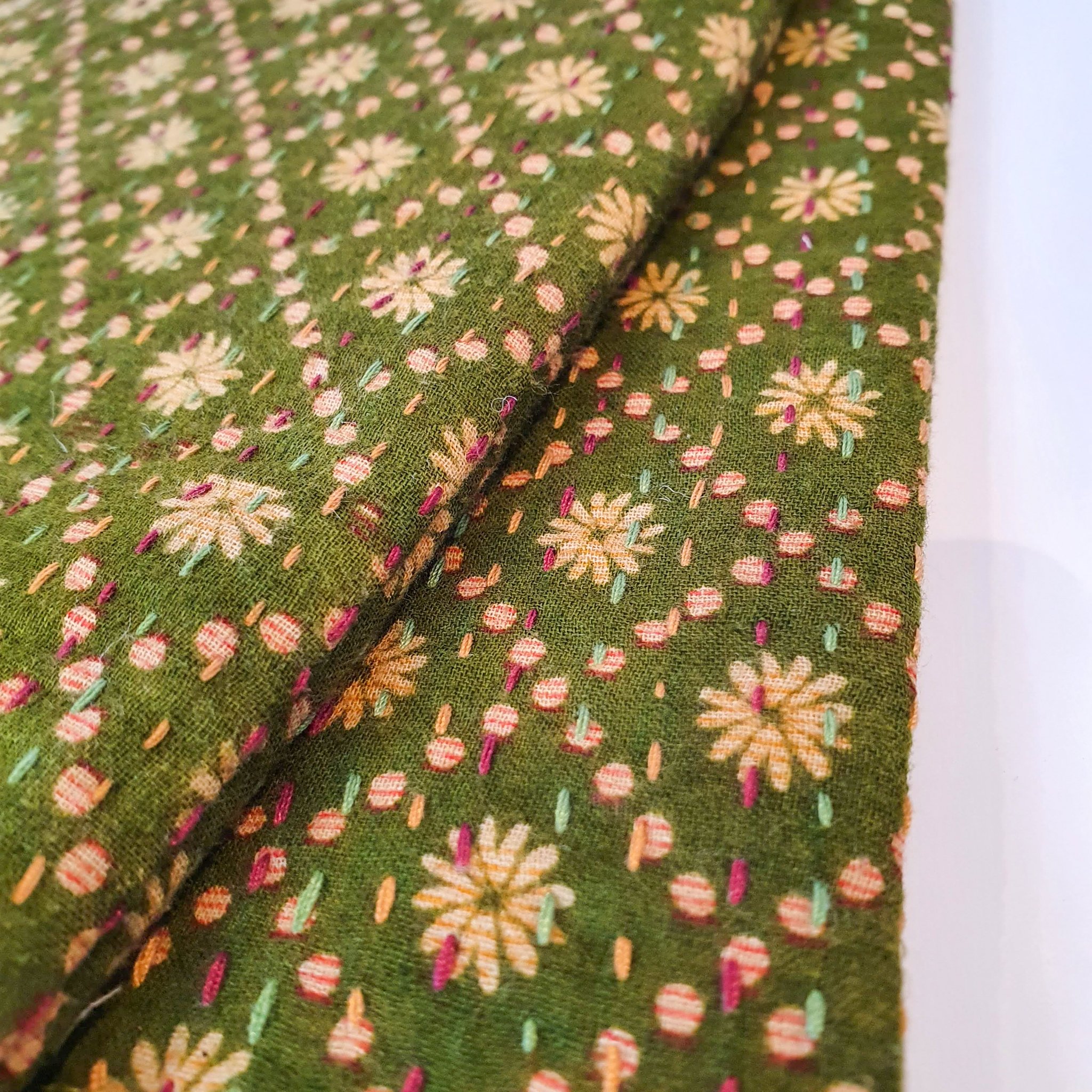 Upcycled sari clutch featuring vibrant colors and intricate kantha stitch embroidery, perfect for carrying essentials.