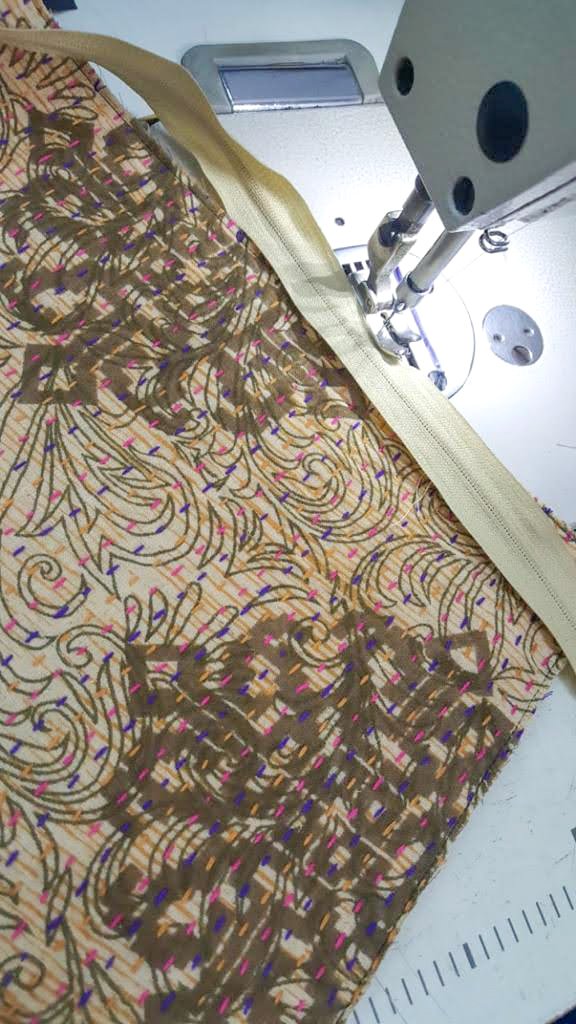 Upcycled sari clutch featuring vibrant colors and intricate kantha stitch embroidery, perfect for carrying essentials.