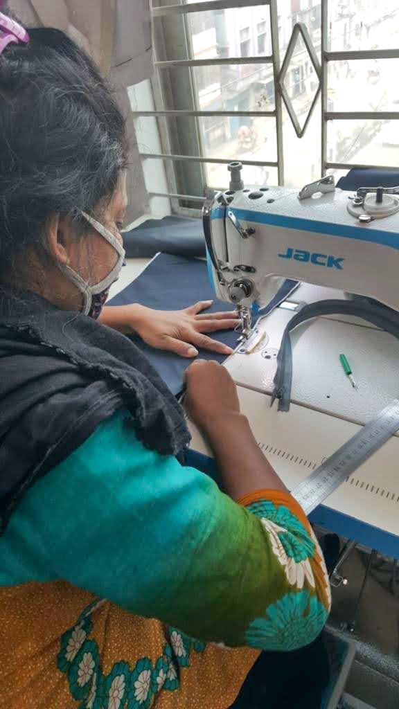 Upcycled sari clutch featuring vibrant colors and intricate kantha stitch embroidery, perfect for carrying essentials.