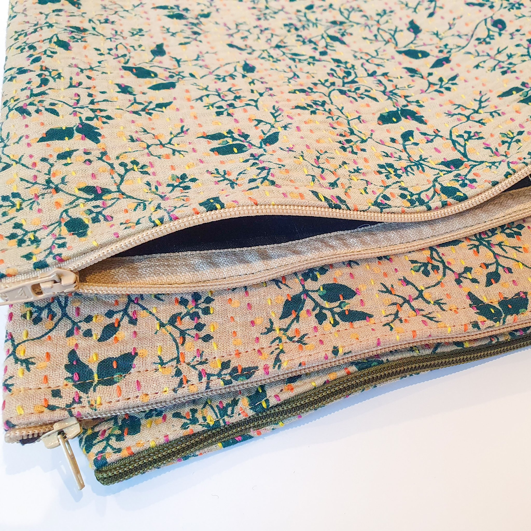 Upcycled sari clutch featuring vibrant colors and intricate kantha stitch embroidery, perfect for carrying essentials.