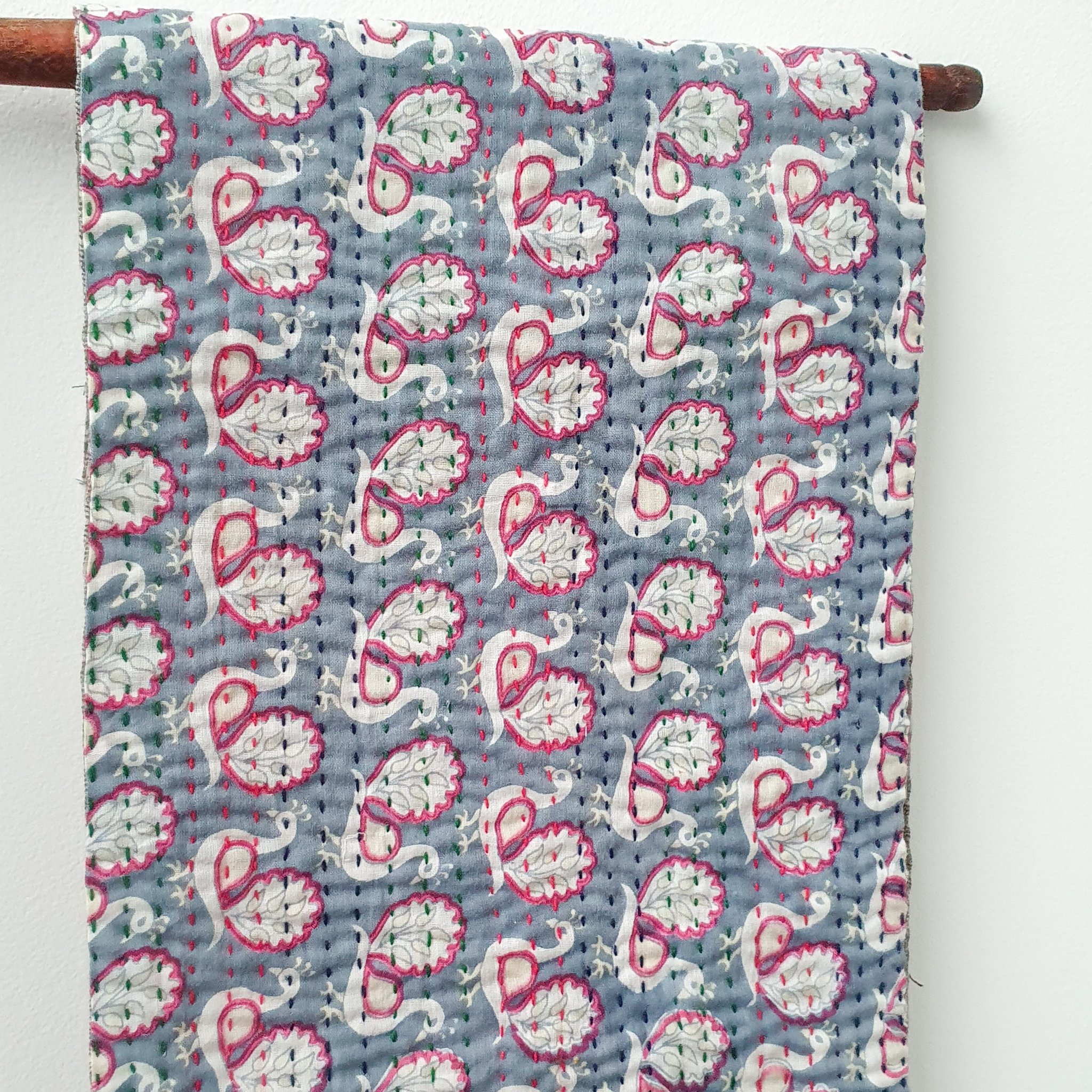 A vibrant upcycled sari cotton kantha infinity scarf showcasing unique patterns and colors, hand-stitched with traditional kantha technique.