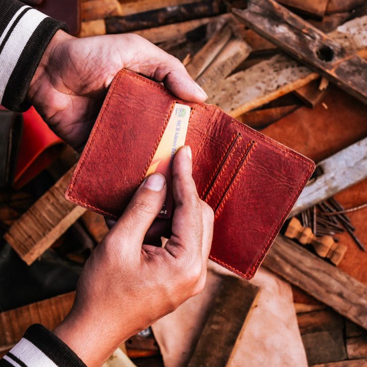 Vintage Bi-Fold Card/Cash Holder in Rust made from genuine cow leather, featuring four credit card slots and one cash compartment.