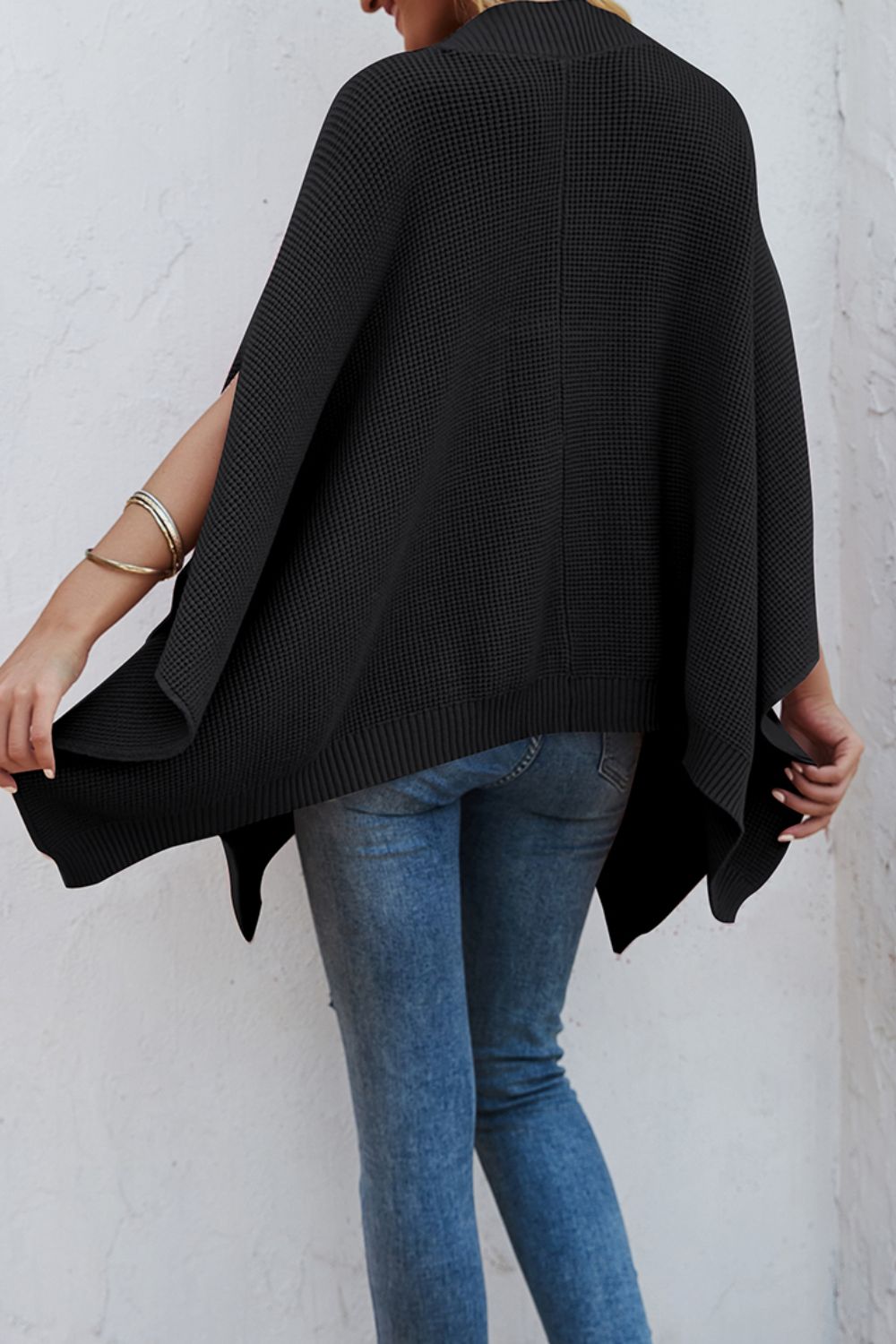 Waffle-Knit Pocketed Cape Sleeve Sweater in a cozy design with pockets, showcasing its stylish waffle texture and relaxed fit.