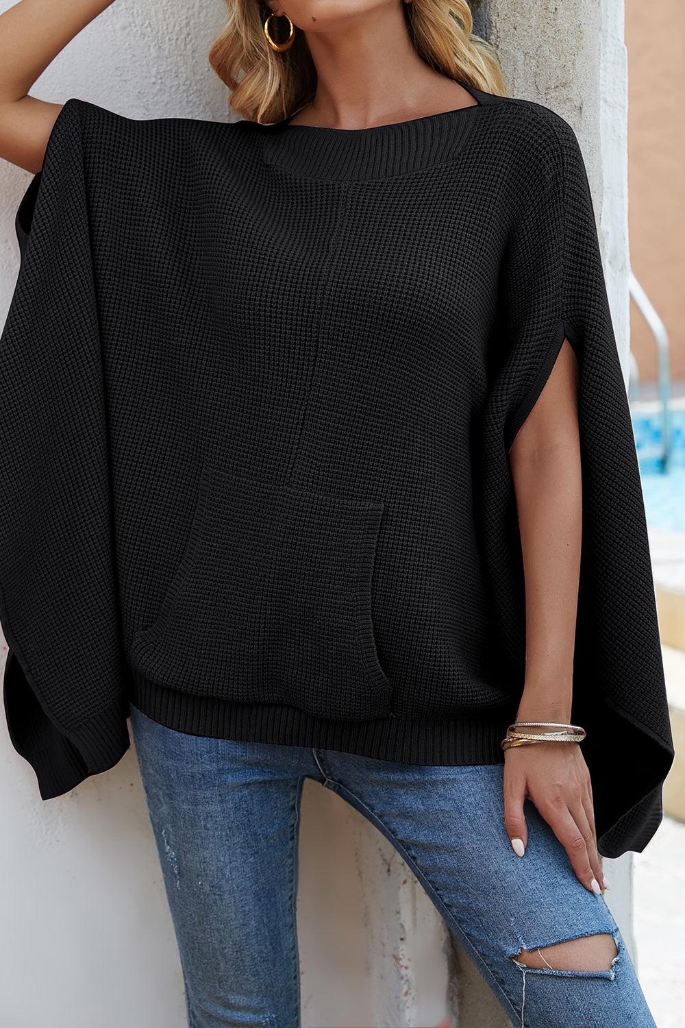Waffle-Knit Pocketed Cape Sleeve Sweater in a cozy design with pockets, showcasing its stylish waffle texture and relaxed fit.