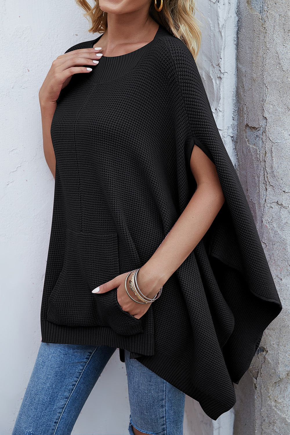 Waffle-Knit Pocketed Cape Sleeve Sweater in a cozy design with pockets, showcasing its stylish waffle texture and relaxed fit.