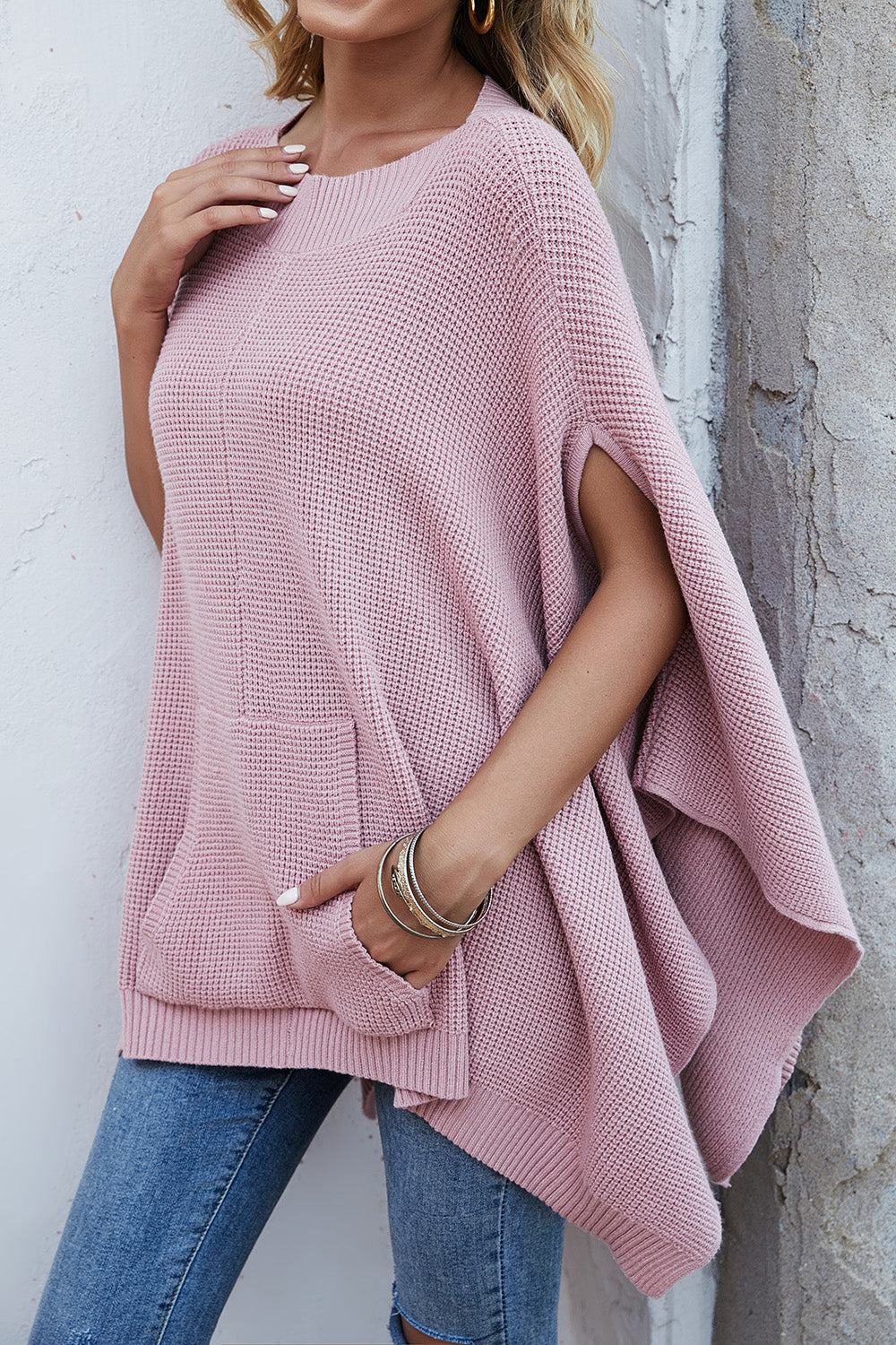 Waffle-Knit Pocketed Cape Sleeve Sweater in a cozy design with pockets, showcasing its stylish waffle texture and relaxed fit.