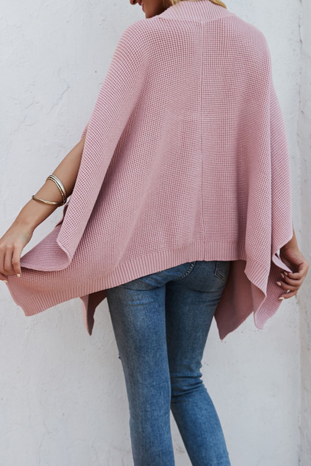 Waffle-Knit Pocketed Cape Sleeve Sweater in a cozy design with pockets, showcasing its stylish waffle texture and relaxed fit.