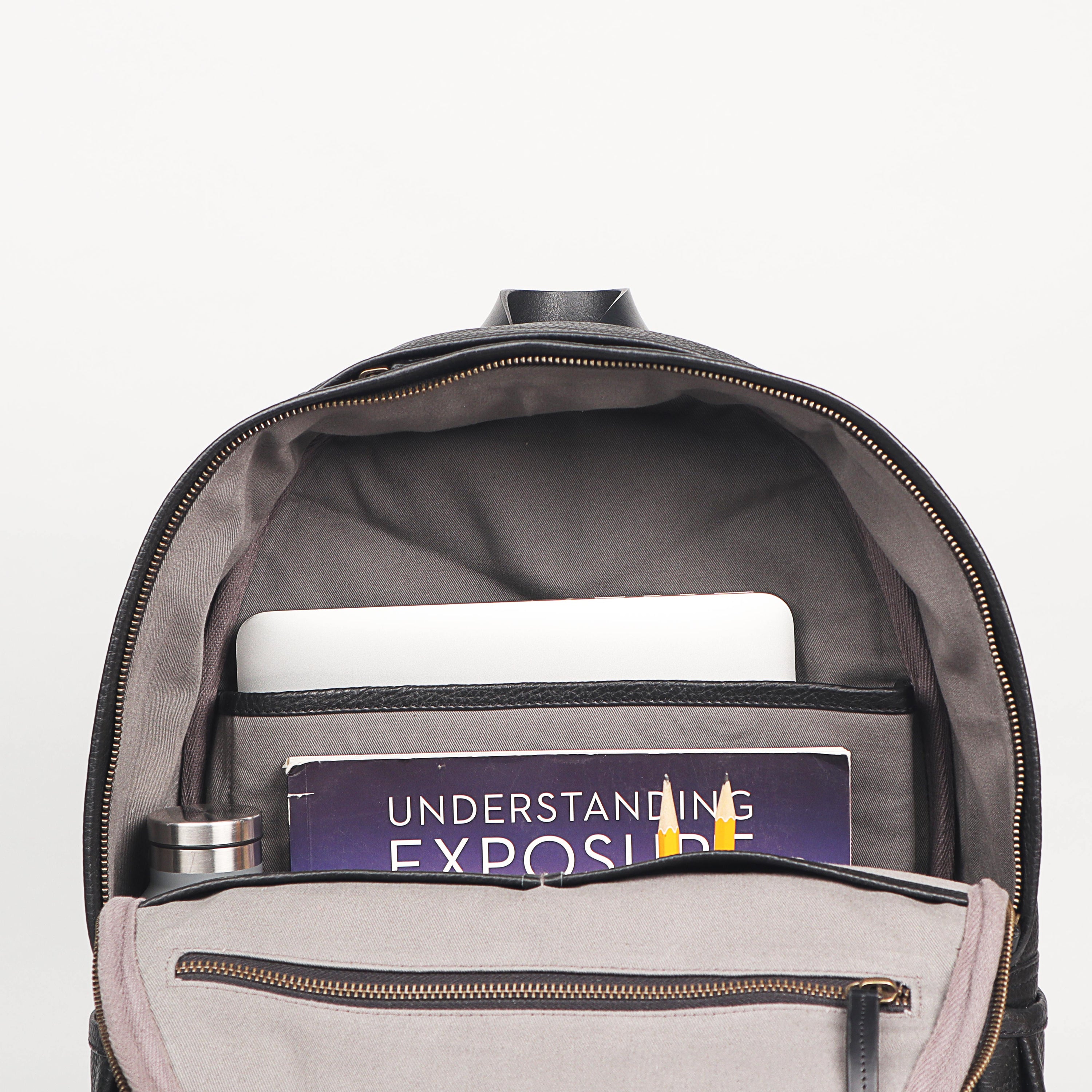 Weaved Journey Leather Backpack showcasing premium full grain leather, padded laptop compartment, and adjustable shoulder straps.