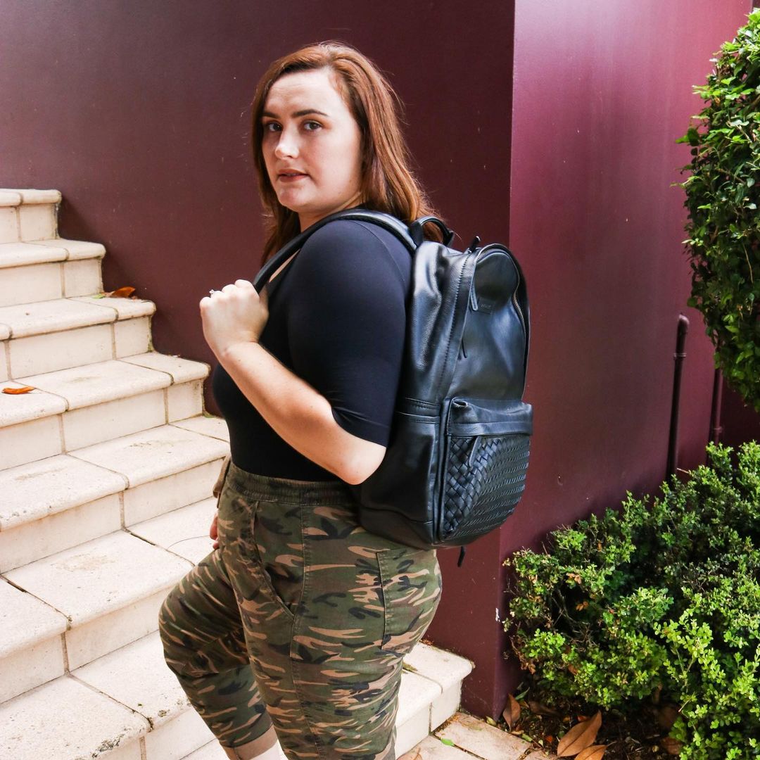 Weaved Journey Leather Backpack showcasing premium full grain leather, padded laptop compartment, and adjustable shoulder straps.