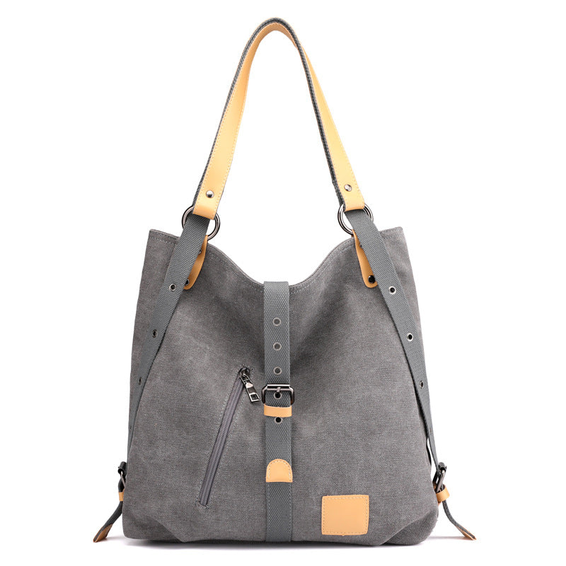 A stylish Women's Large Capacity Canvas Shoulder Bag in a neutral color, showcasing its spacious design and multiple pockets.