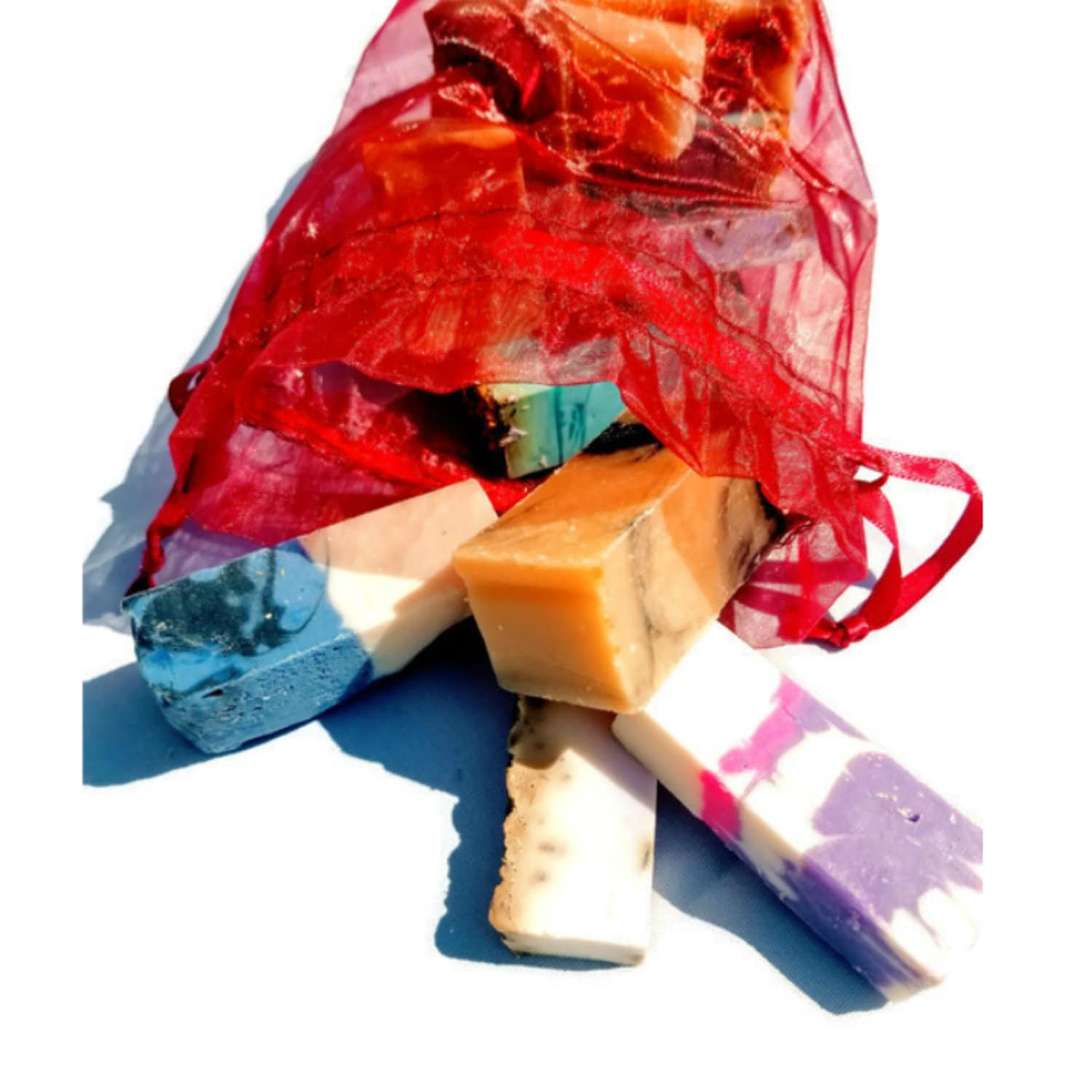 A vibrant jewel-toned bag filled with assorted handmade soap samples, showcasing various colors and textures.