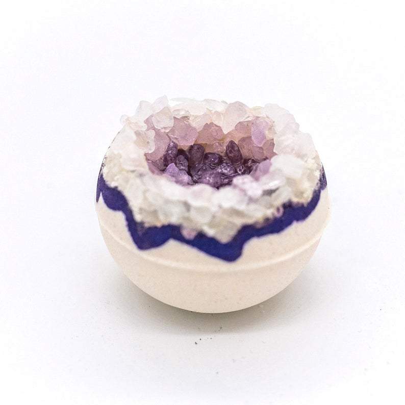 Artisan Amethyst Geo Vegan Bath Bomb with vibrant colors and geode design, surrounded by lavender flowers.