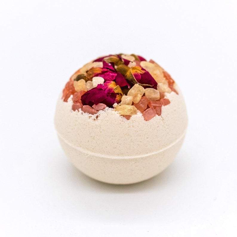 Artisan Wild Rose Petal Vegan Bath Bomb with whole rose buds and petals, showcasing its vibrant colors and luxurious texture.