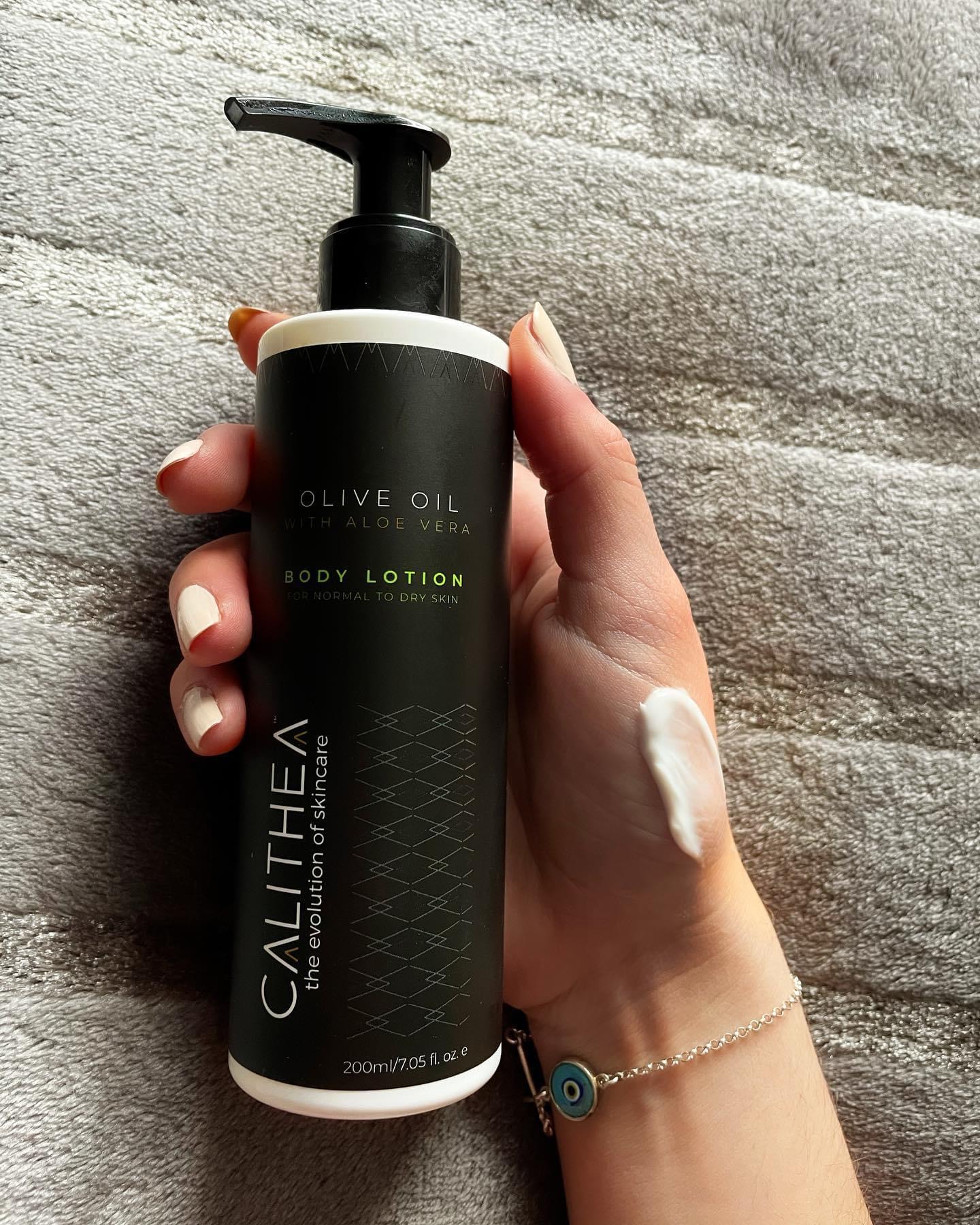 Close-up of hand holding lotion.