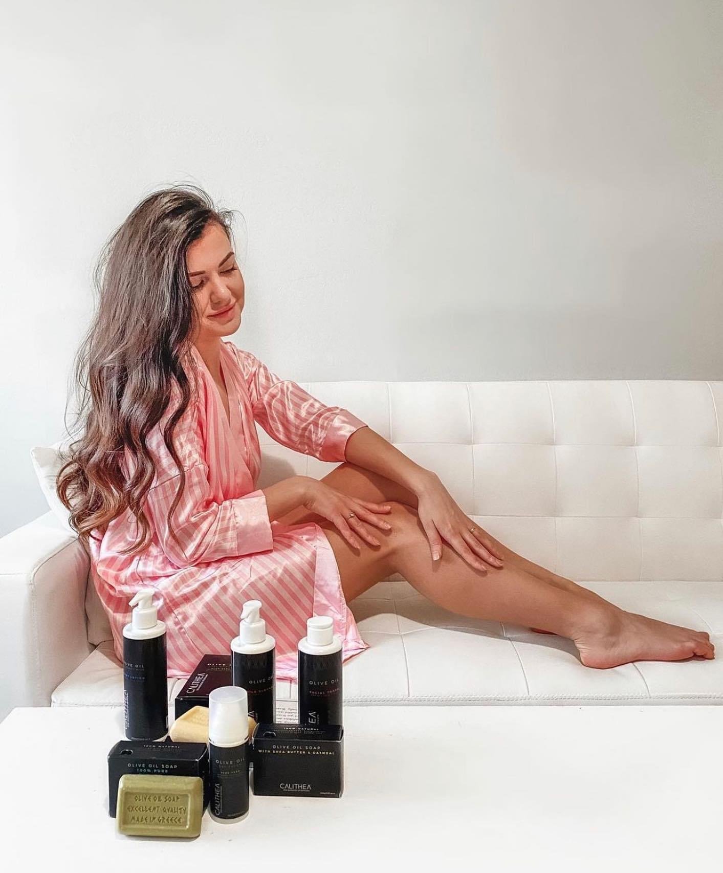 Woman applying skincare products.