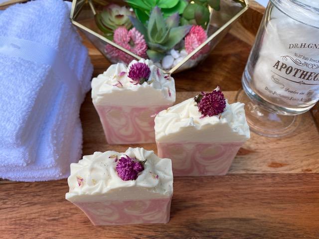Cherry Bomb Cold Process Soap with flower embed, showcasing vibrant pink color and decorative icing top.