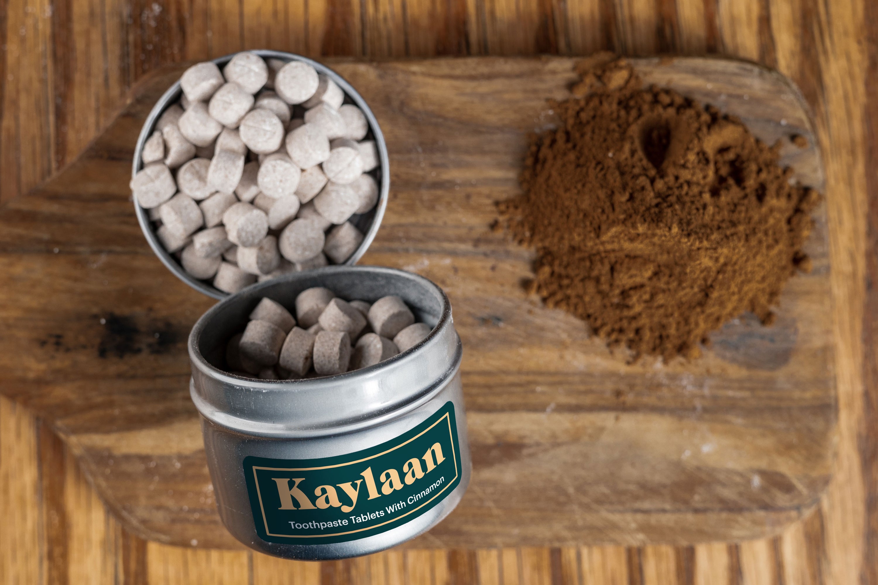 Cinnamon Toothpaste Tablets in a small eco-friendly package, showcasing their unique shape and color.