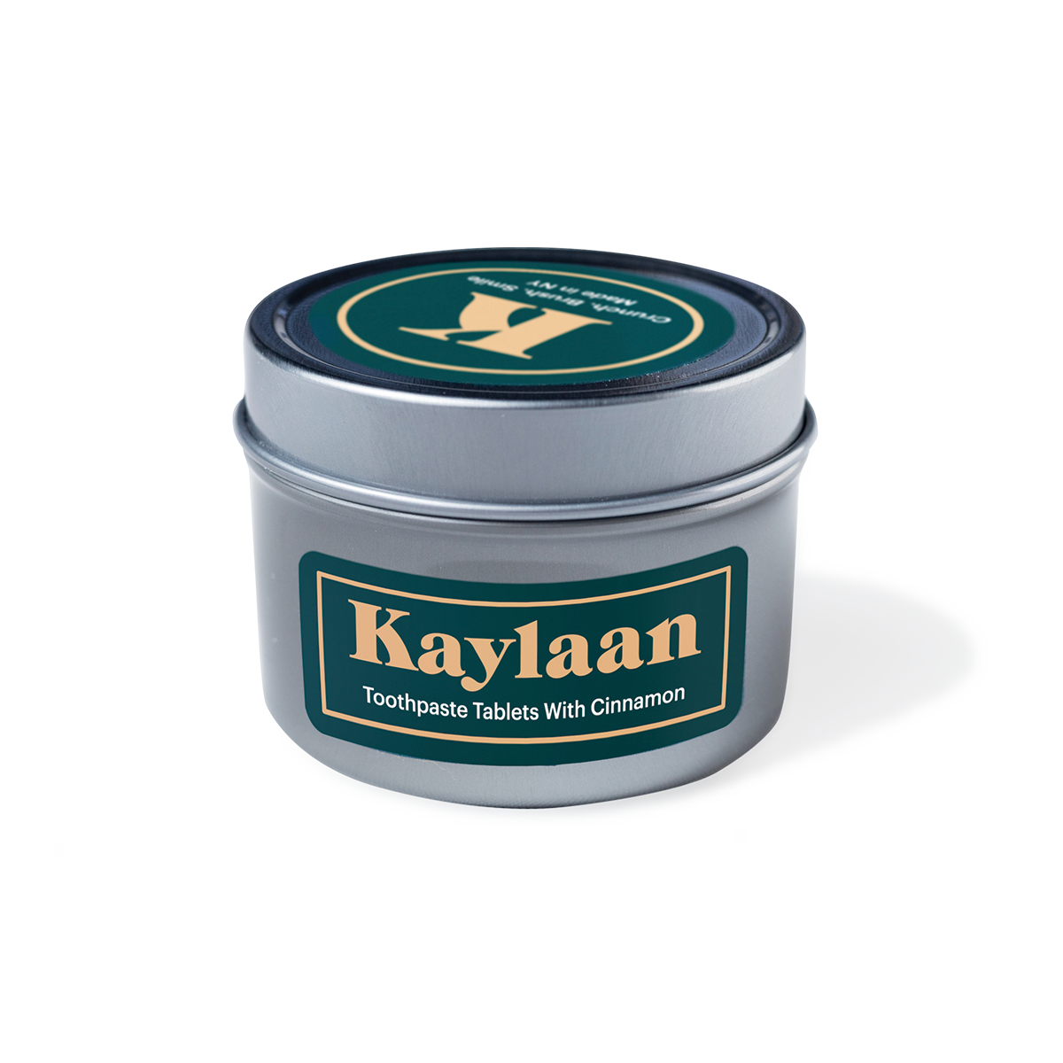 Cinnamon Toothpaste Tablets in a small eco-friendly package, showcasing their unique shape and color.