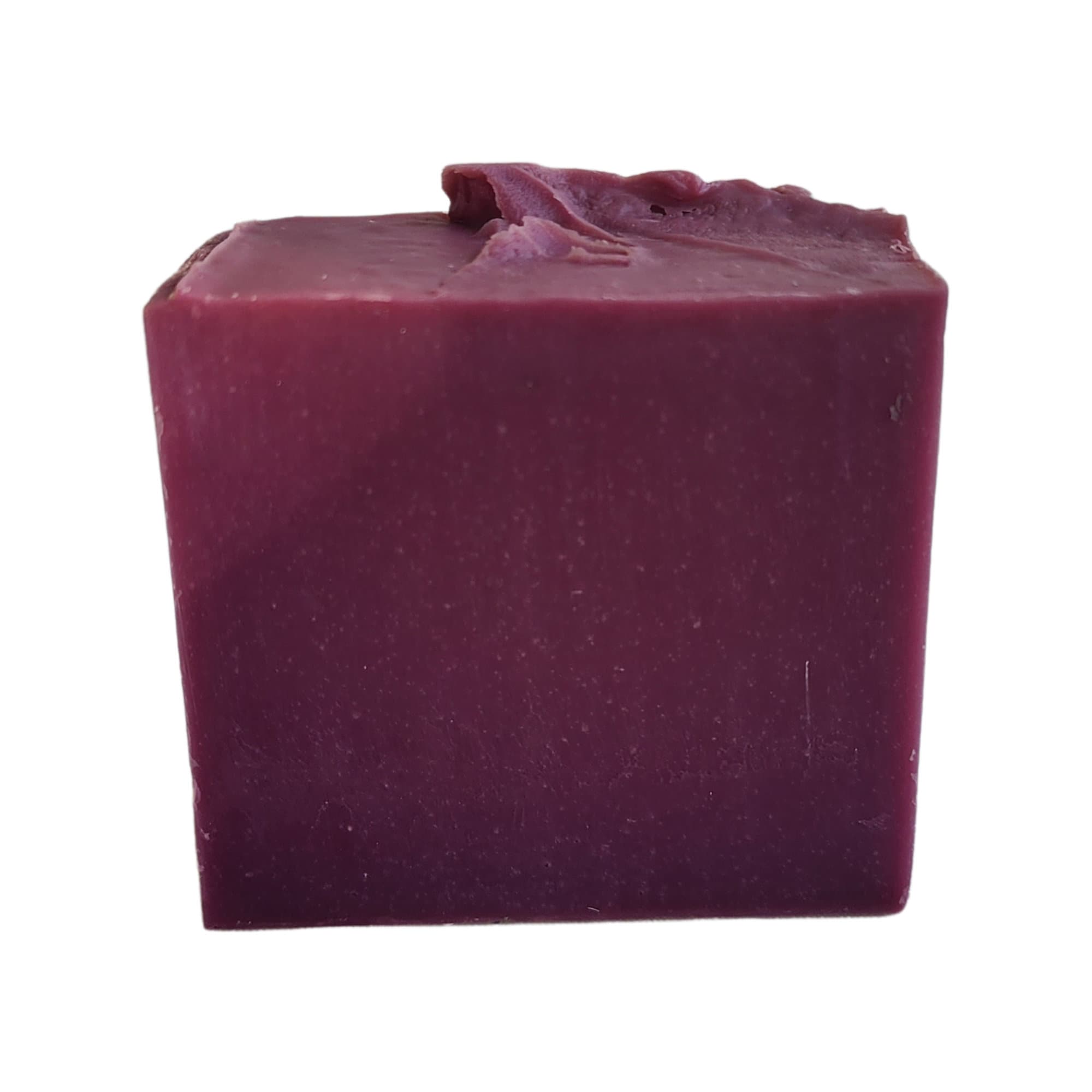 Cranberry Spice Soap bar with a deep cranberry color, showcasing its handcrafted texture and warm, spicy aroma.