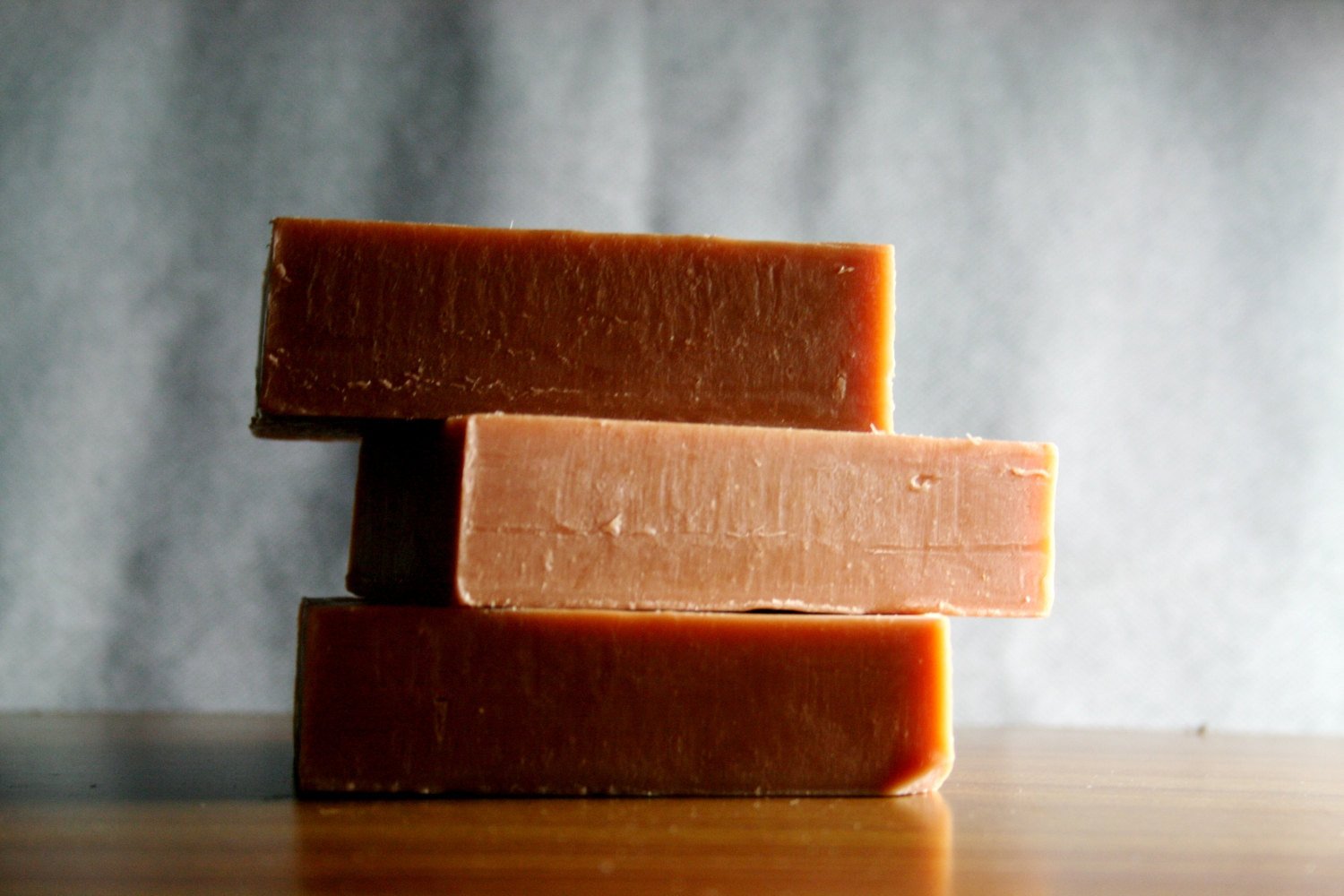 A bar of French Red Clay Soap, showcasing its rich reddish hue and smooth texture, ideal for normal to oily skin types.