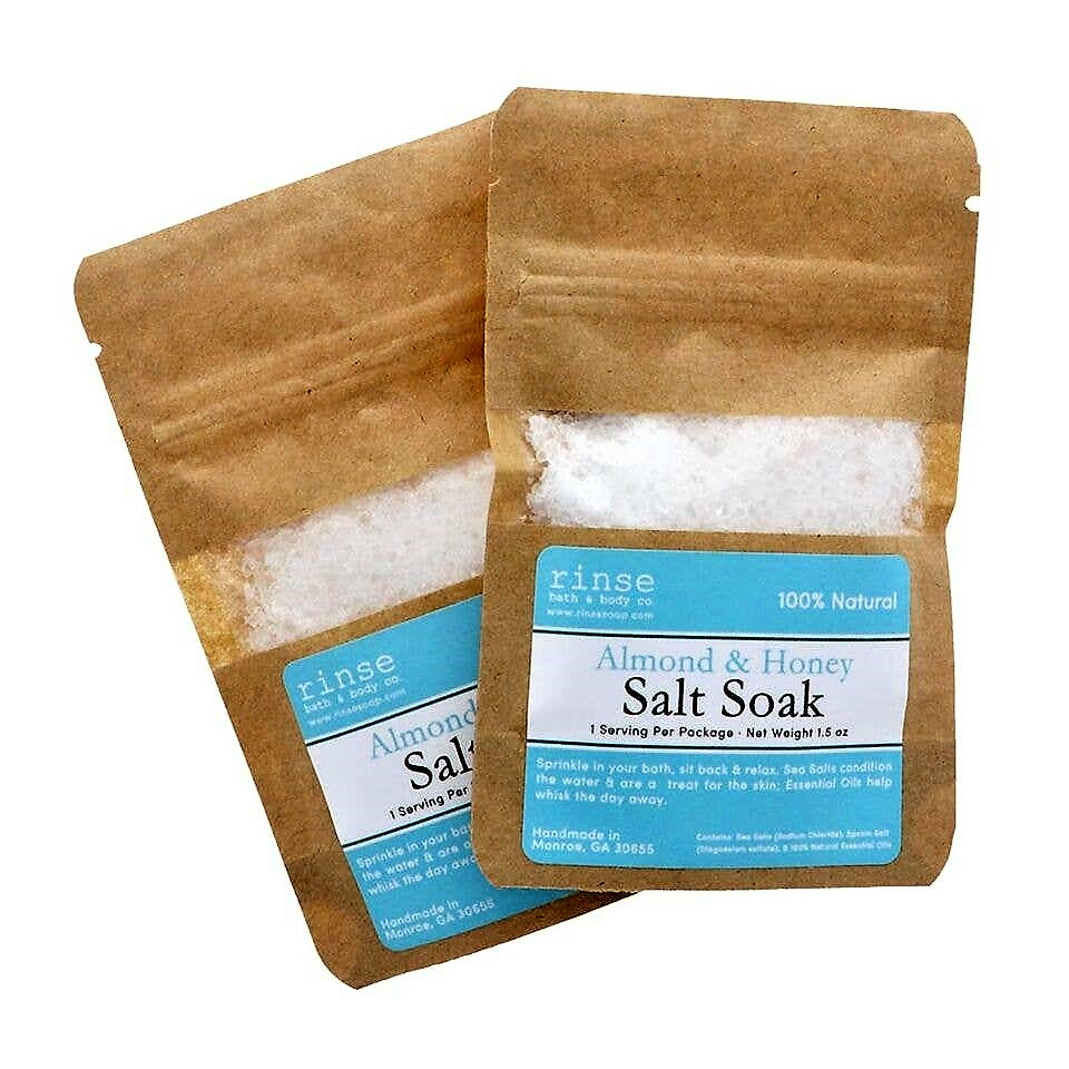 A pack of Honey Almond Salt Soak featuring a blend of sea salt and Epsom salt with a rich almond and cherry scent, perfect for soothing muscles.