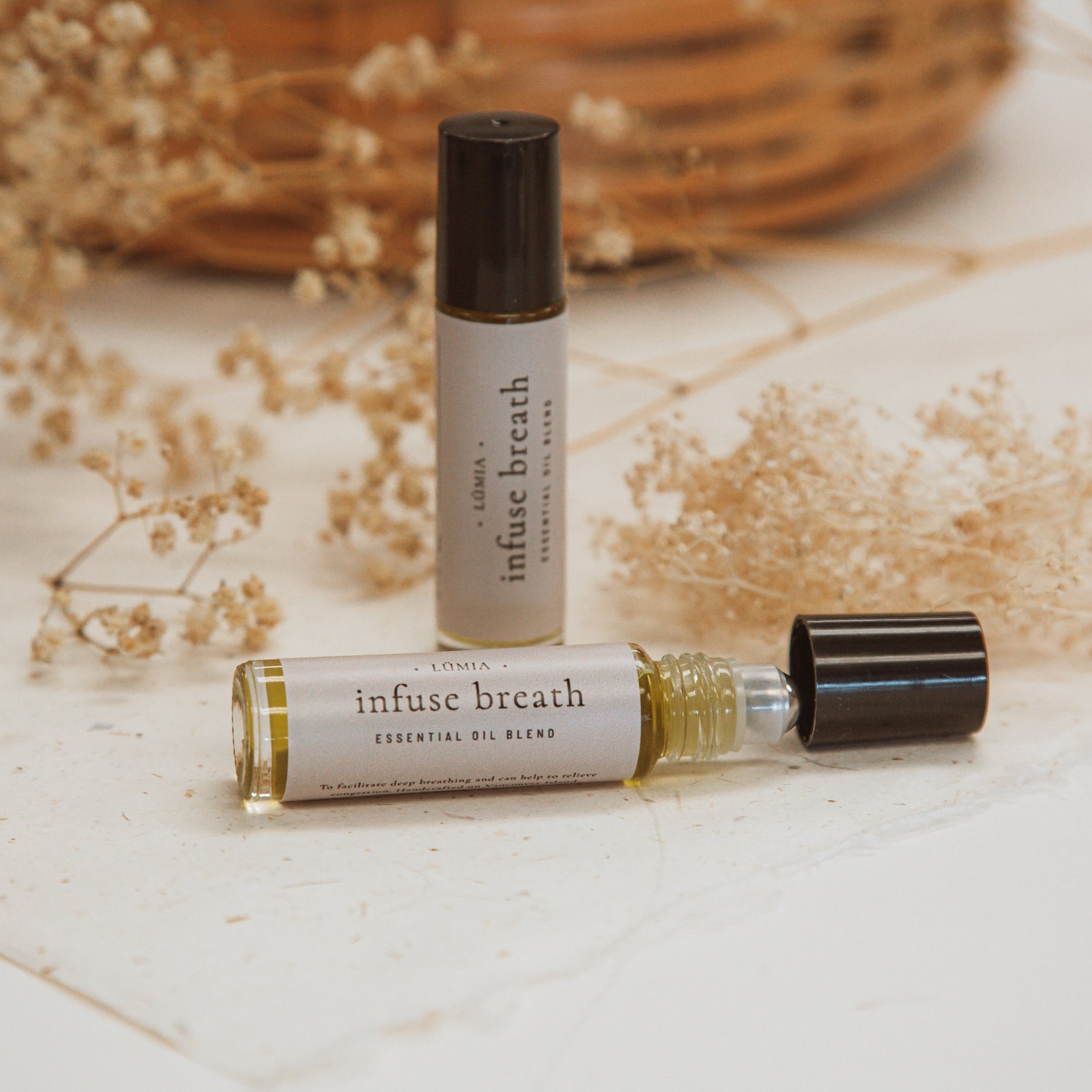 Infuse Breath roll-on essential oil blend featuring Eucalyptus, Tea Tree, and Peppermint in a sleek bottle.